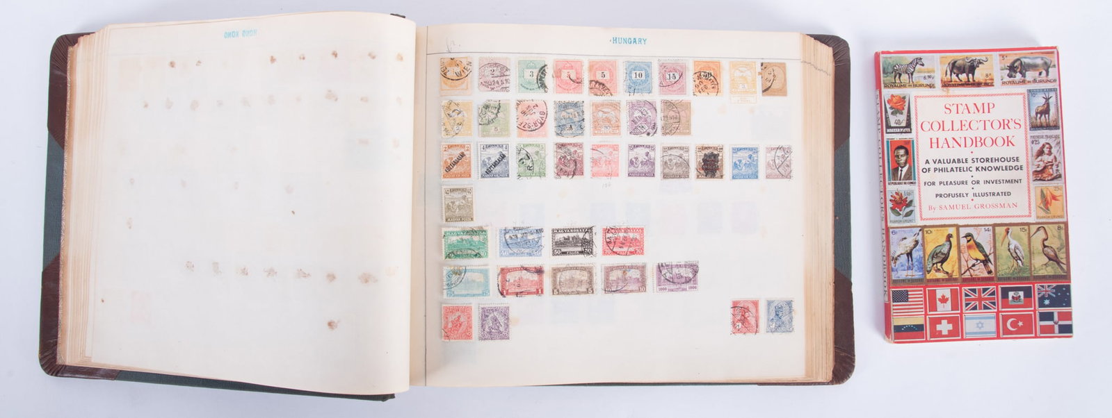 Collector's Book of International Stamps and Handbook: Collector's Book of International Stamps and Handbook Large bound book of semi-antique global stamps, partially full with cancelled and used stamps from 166 countries and territories. Dated from