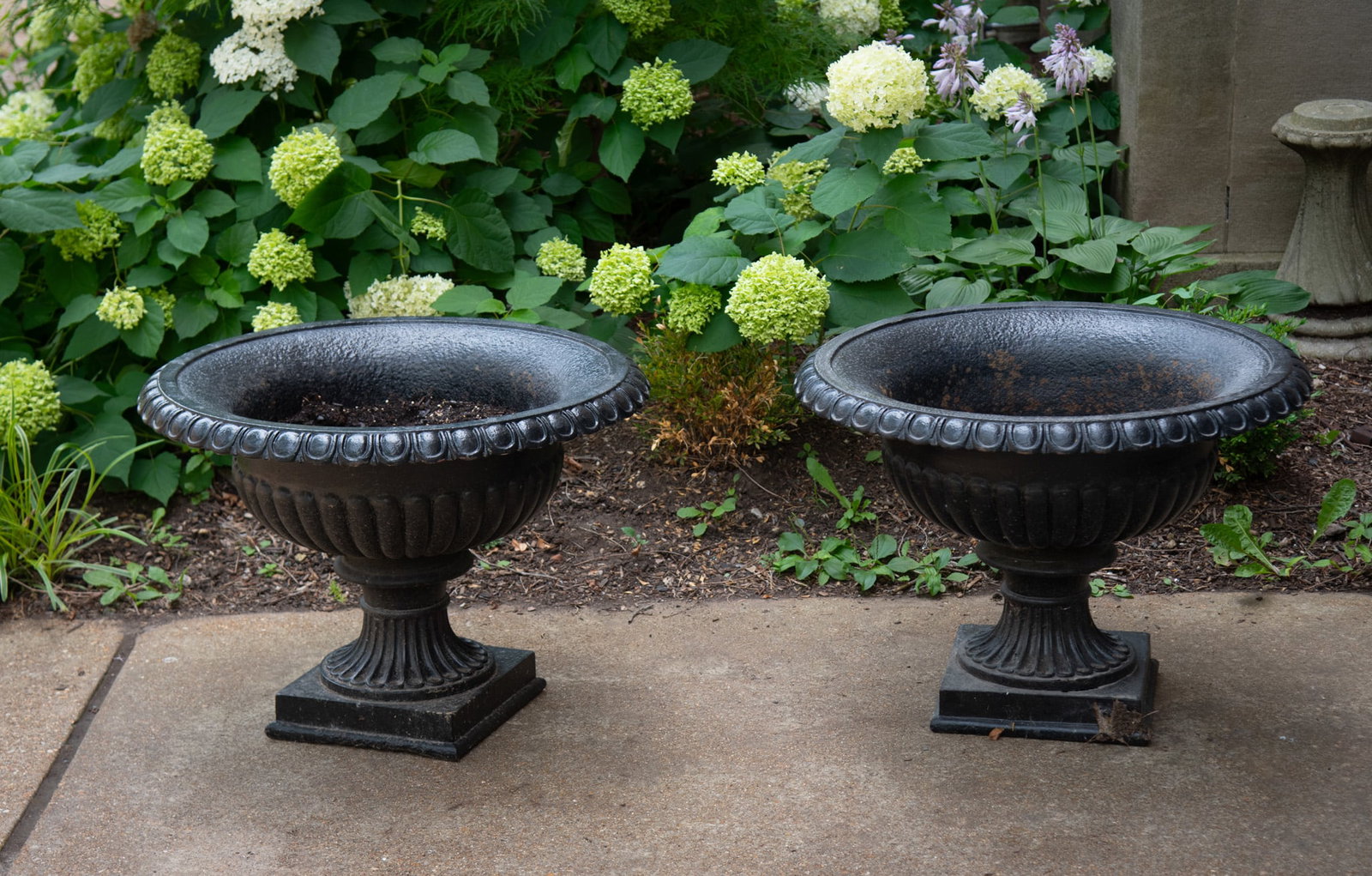 A Pair of French Empire Style Cast Iron Garden Urns: A Pair of French Empire Style Cast Iron Garden Urns Late 19th Century Height: 22 inches; Diameter of the top: 30 inches