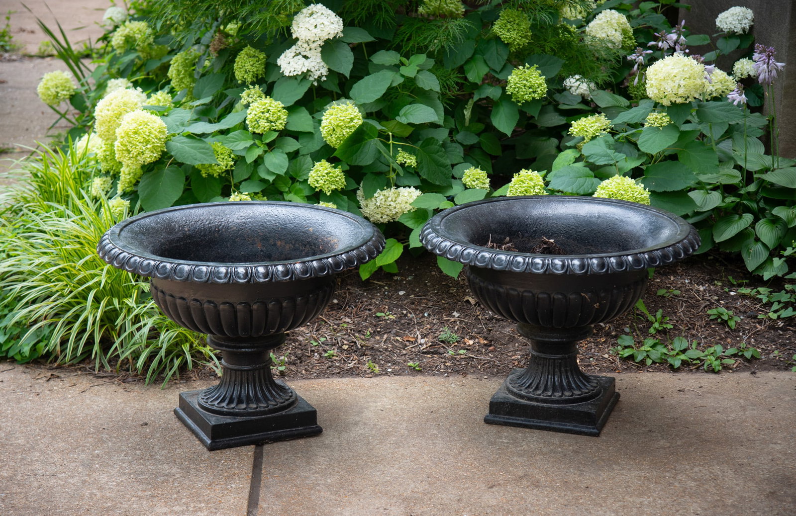 A Pair of French Empire Style Cast Iron Garden Urns: A Pair of French Empire Style Cast Iron Garden Urns Late 19th Century Height: 22 inches; Diameter of the top: 30 inches