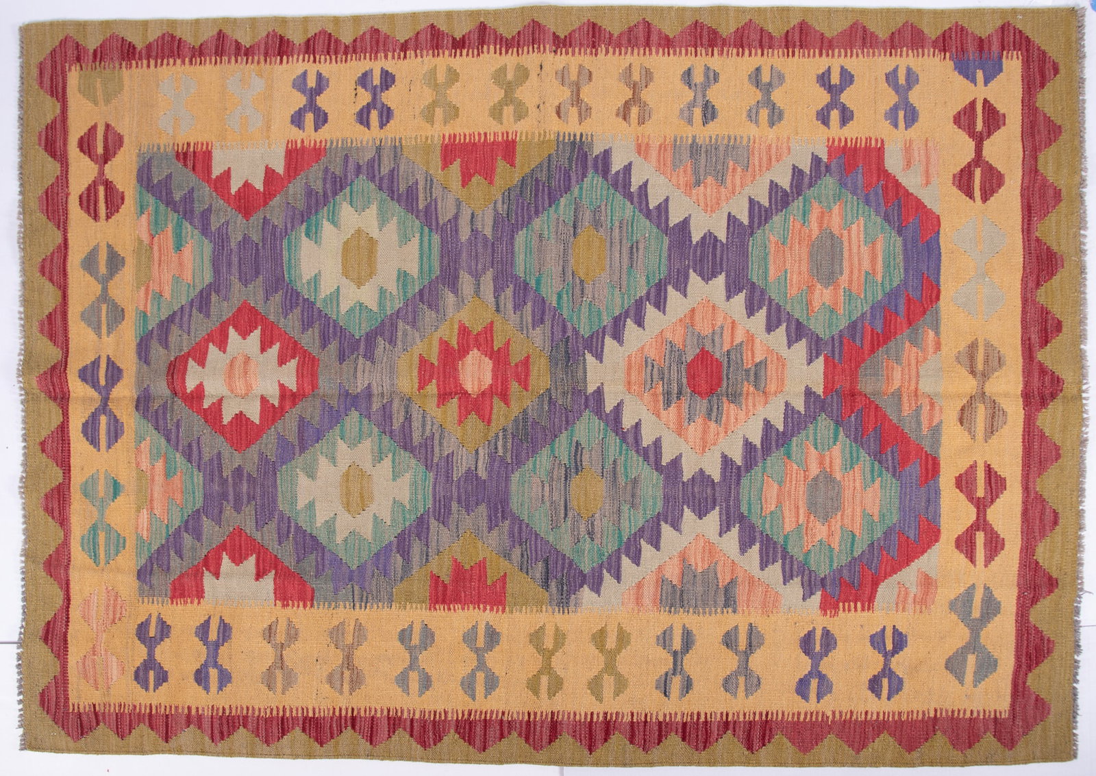 Hand Knotted Kilim Area Rug: Hand Knotted Kilim Area Rug Diamond patterned field in shades of purple, green, tan and red all with stepped edges. 5' x 6' 9"