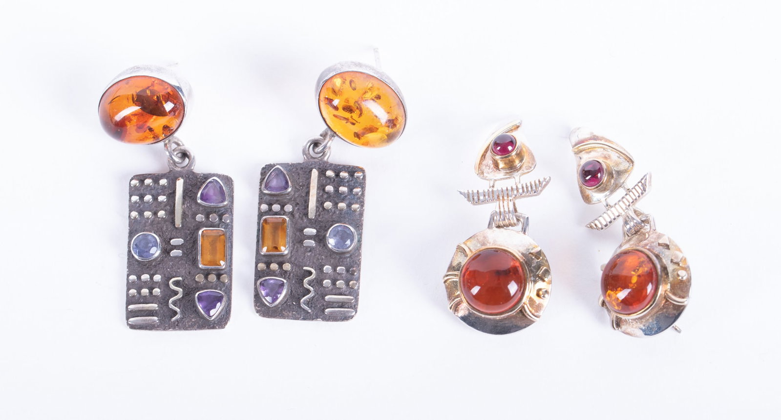 Sterling Silver Amber Earrings signed Soma paired with Amber & Multi Stone Earrings: Sterling Silver Amber Earrings signed Soma paired with Amber & Multi Stone Earrings The Soma earrings have an amber cabochon and a small garnet cabochon. They are 1 1/2 inches long. The second pair al