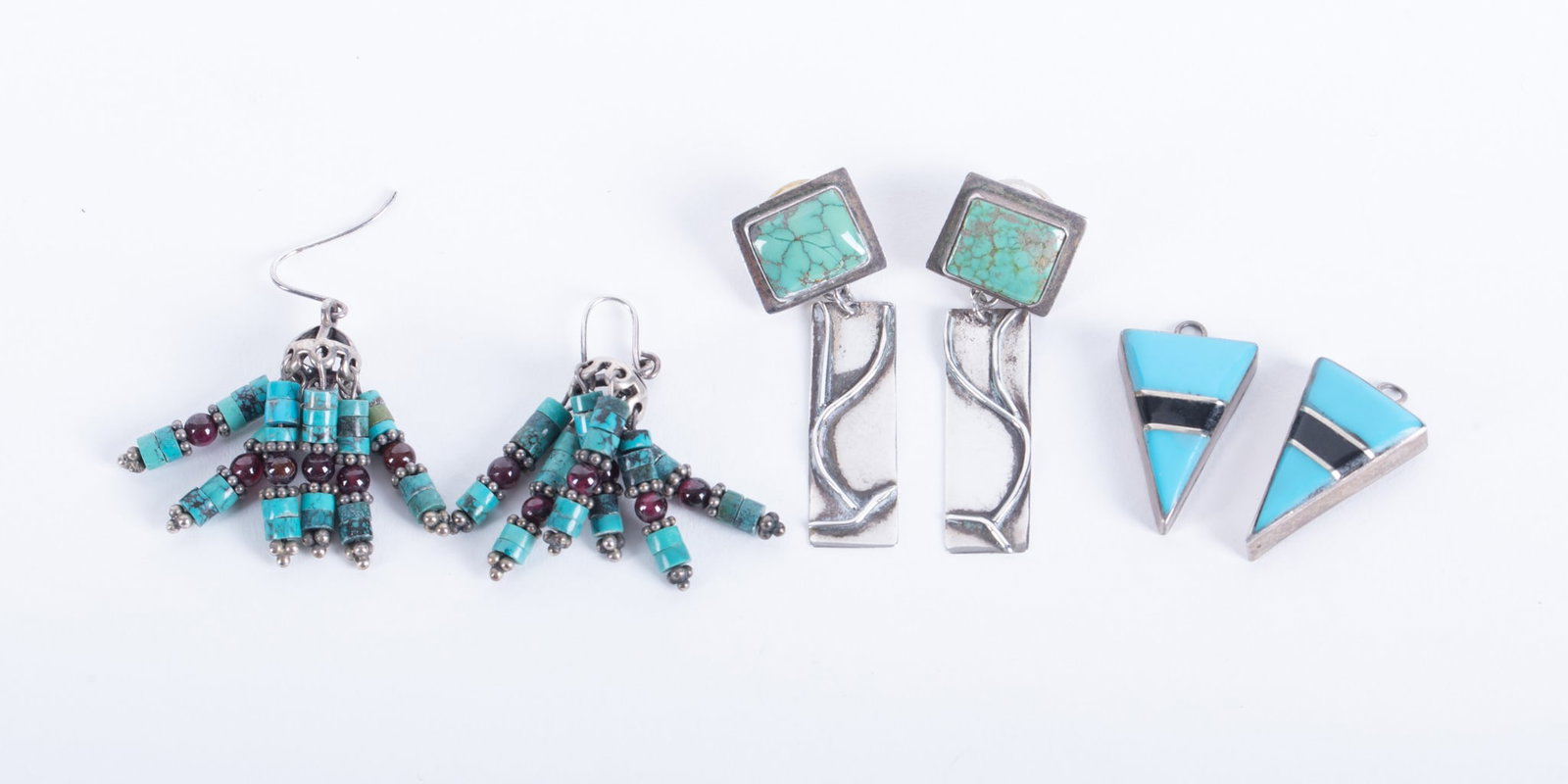 Three Pairs of Sterling Silver Turquoise Earrings: Three Pairs of Sterling Silver Turquoise Earrings This lot includes a pair of turquoise/amethyst dangle earrings-1 3/4 inches long. Next we have a pair with rectangular green turquoise. These have a d