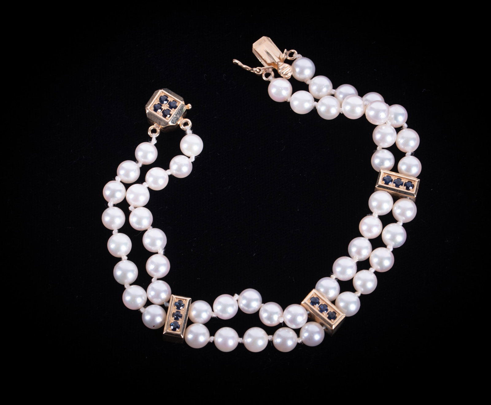 Cultured Pearl Bracelet w/14K Sapphire Spacer Bars: Cultured Pearl Bracelet w/14K Sapphire Spacer Bars This lovely bracelet has a double row of 5 1/2mm pearls separated by three gold/sapphire spacer bars, each signed "Joshua" 14k. The hidden clasp is