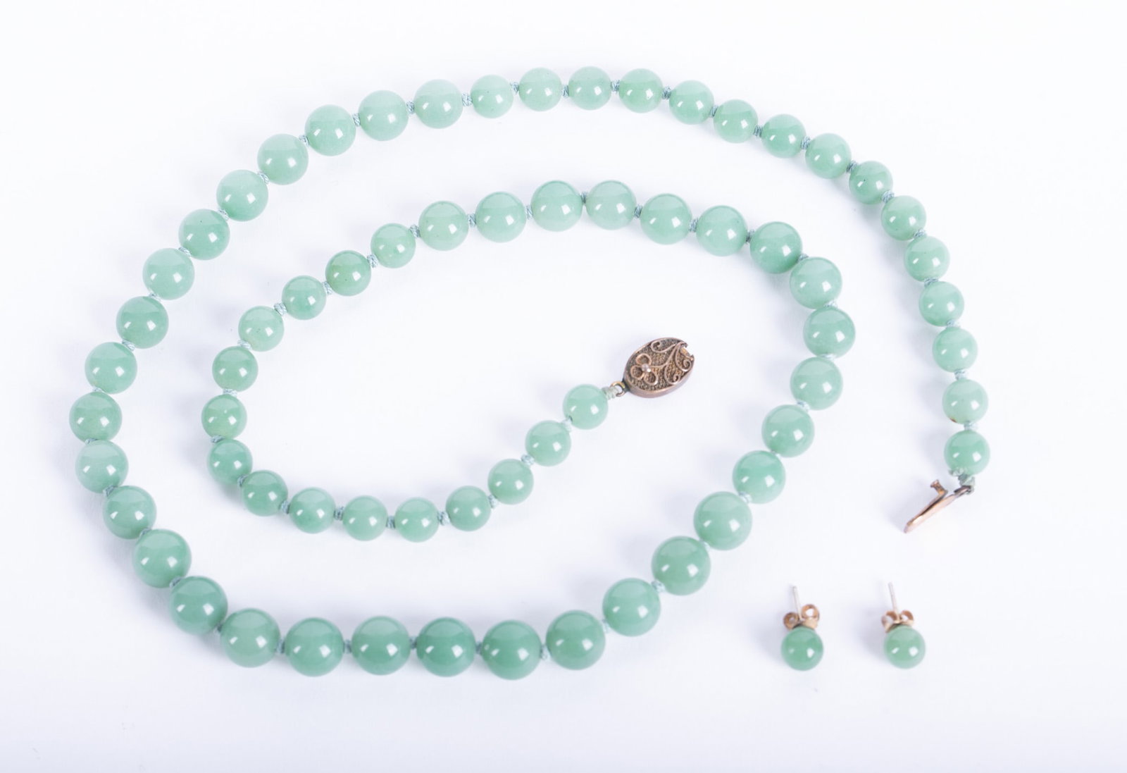 Jadeite Beaded Necklace with Earrings: Jadeite Beaded Necklace with Earrings The necklace is graduated with the largest bead being 11.3mm. Length is 28 inches and the clasp is vermeil. The earrings studs are 8mm.