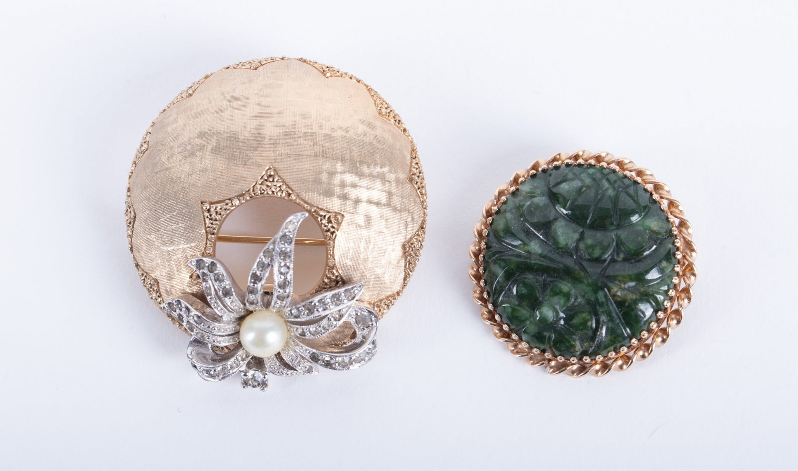 Carved Jade Brooch in 14k along with Costume Designer Brooch: Carved Jade Brooch in 14k along with Costume Designer Brooch The jade brooch is set in yellow gold. It measures 1 1/8 inches in diameter and weighs 9.6g including stone. The vintage brooch is signed