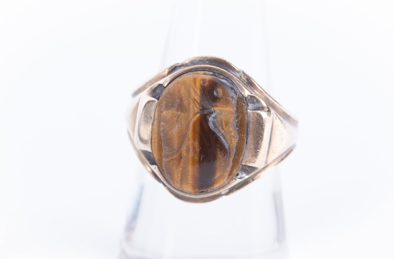 Tiger Eye Cameo Ring set in 10K Yellow Gold: Tiger Eye Cameo Ring set in 10K Yellow Gold The cameo features the profile of a warrior and measures 15.30 x 12.50mm. It is loose in the modified bezel setting-easily fixed. Ring size is 8 and the