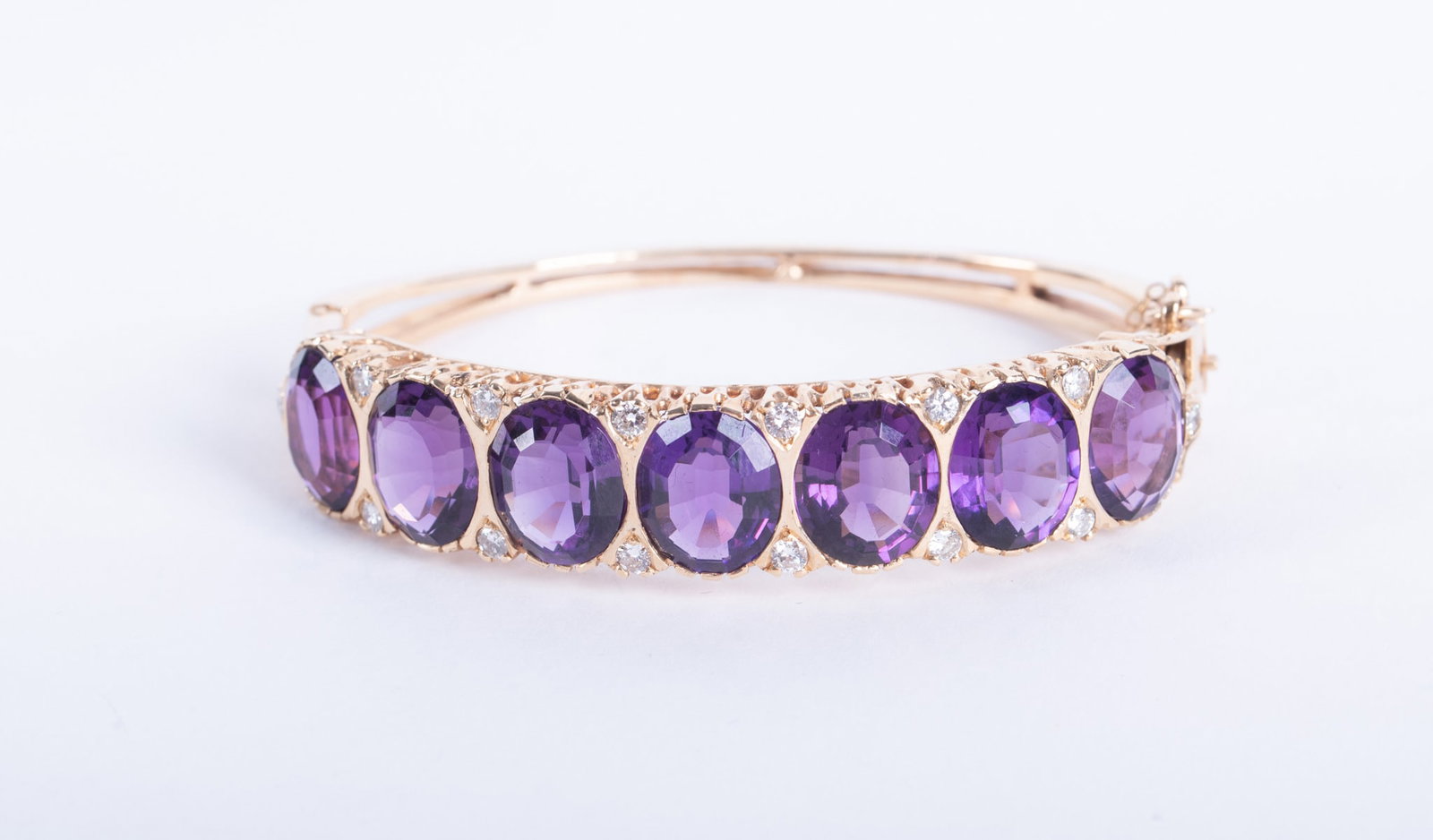 14K Amethyst & Diamond Bracelet: 14K Amethyst & Diamond Bracelet This desirable hinged bangle has 7 excellent quality amethysts measuring 11.16mm x 9.60mm. The alternating diamonds definitely add to the beauty of this bracelet with