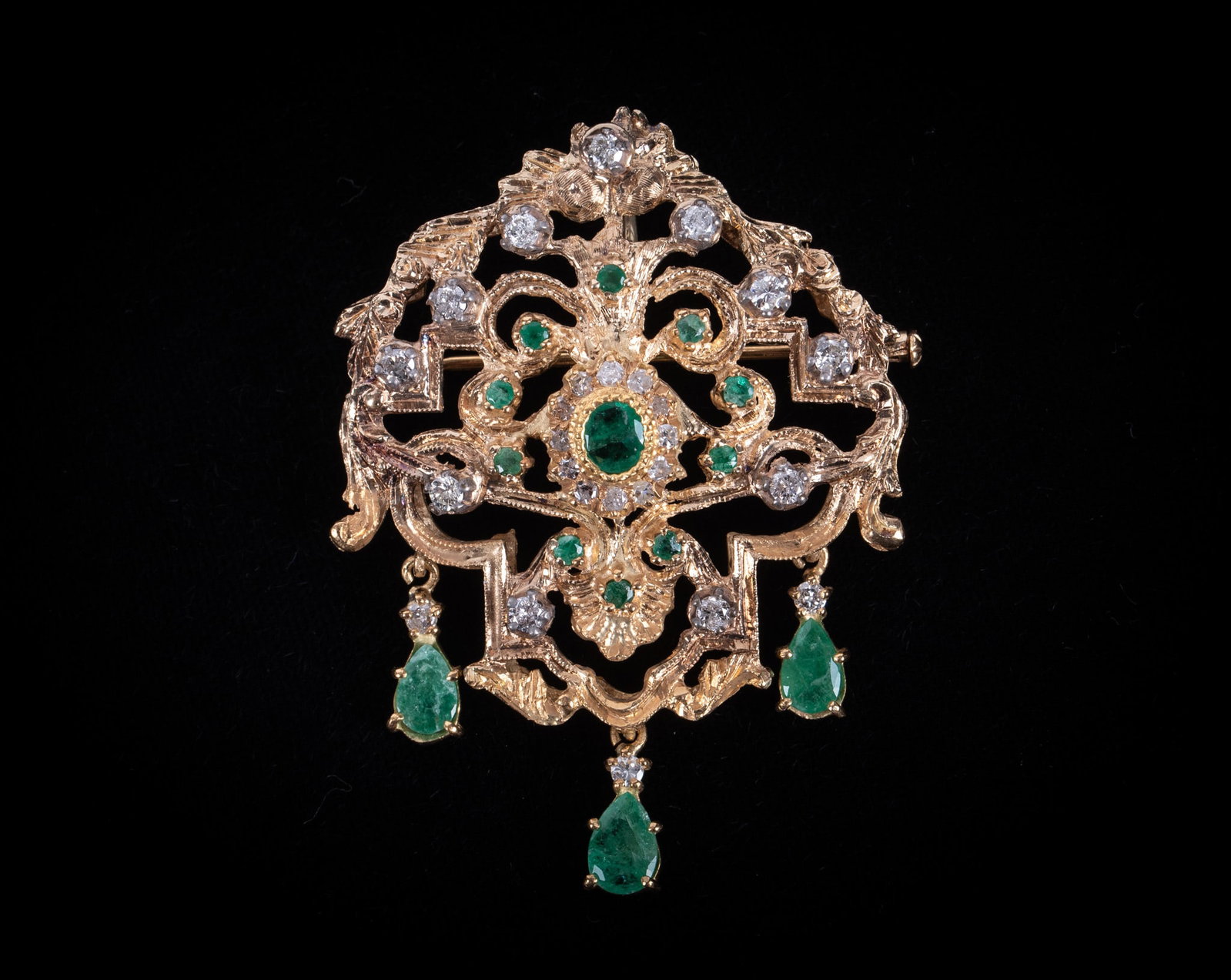 Exquisitely Crafted 18K Yellow Gold Emerald & Diamond Brooch: Exquisitely Crafted 18K Yellow Gold Emerald & Diamond Brooch This exceptionally ornate openwork brooch/pendant has an elaborate Baroque inspired scroll design. The carat weight of the emeralds is as