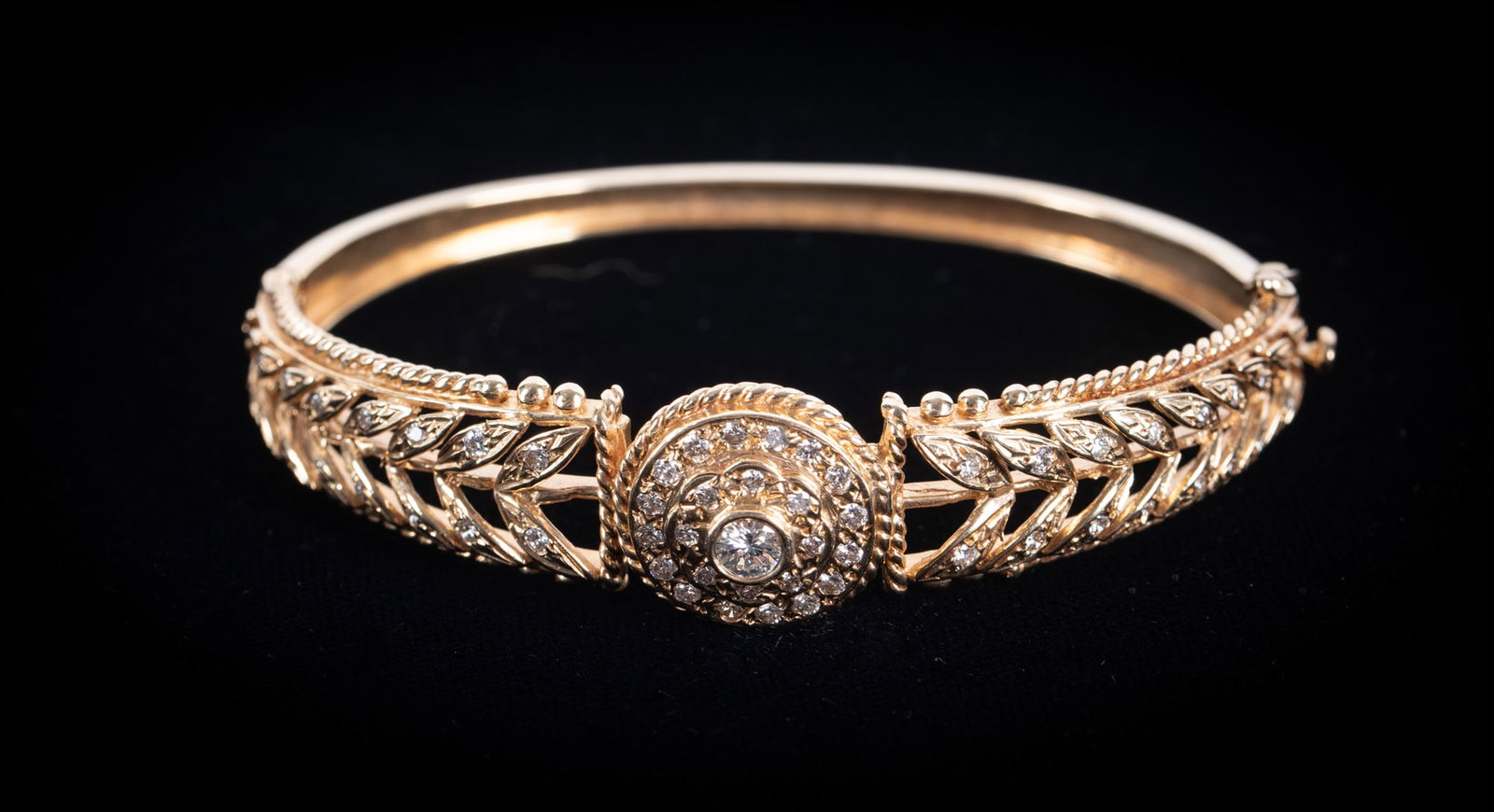 Vintage 14K Yellow Gold Diamond Bracelet: Vintage 14K Yellow Gold Diamond Bracelet This beautiful bracelet has a circular centerpiece encrusted with diamonds. The center stone is .20 carats with the surrounding stones weighing approximately .