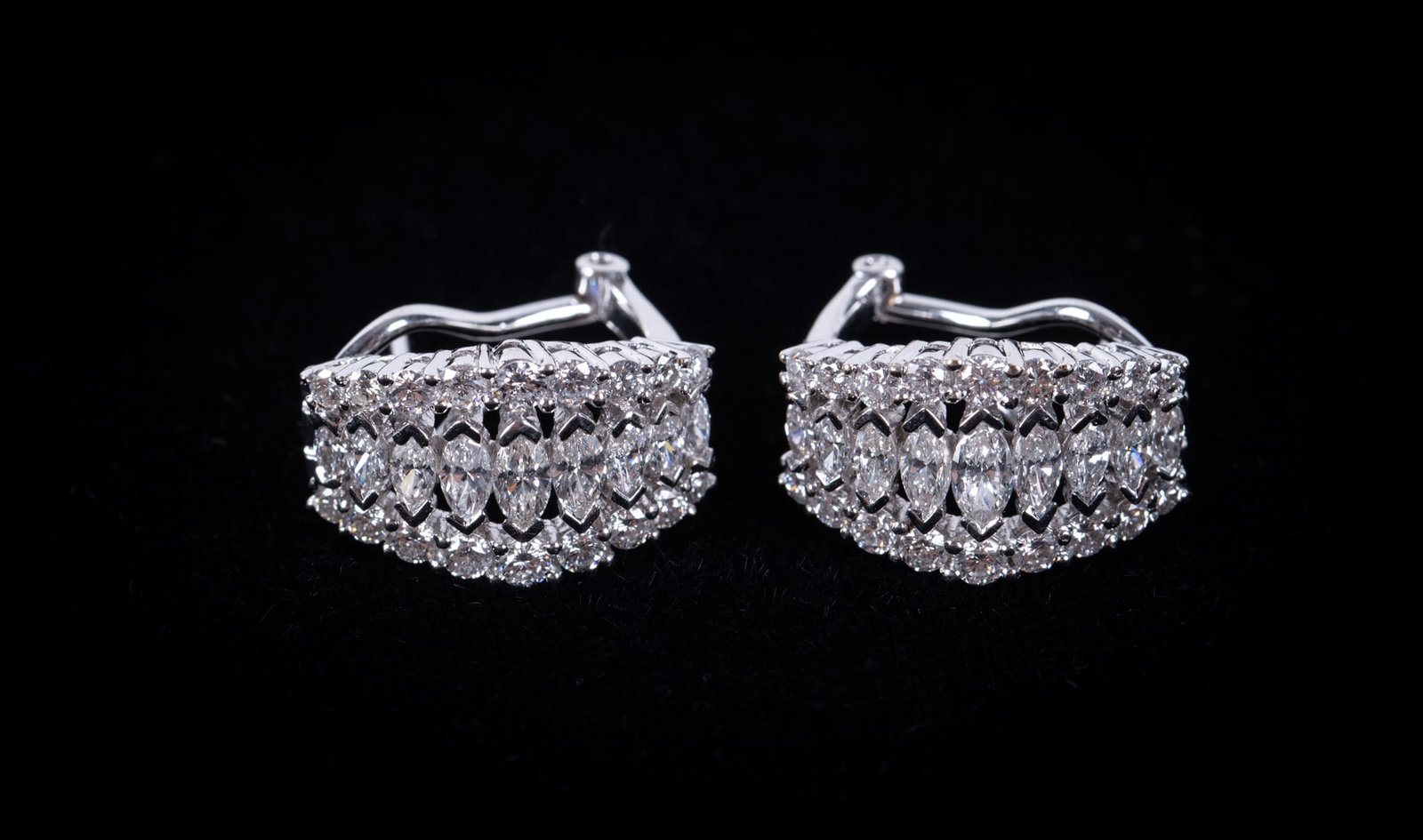 18K White Gold Diamond Earrings: 18K White Gold Diamond Earrings These lovely lever back earrings contain 14 marquise cut diamonds weighing approximately .85CTW, G-H in color & VS2 in clarity bordered by 36 brilliant cut diamonds wei