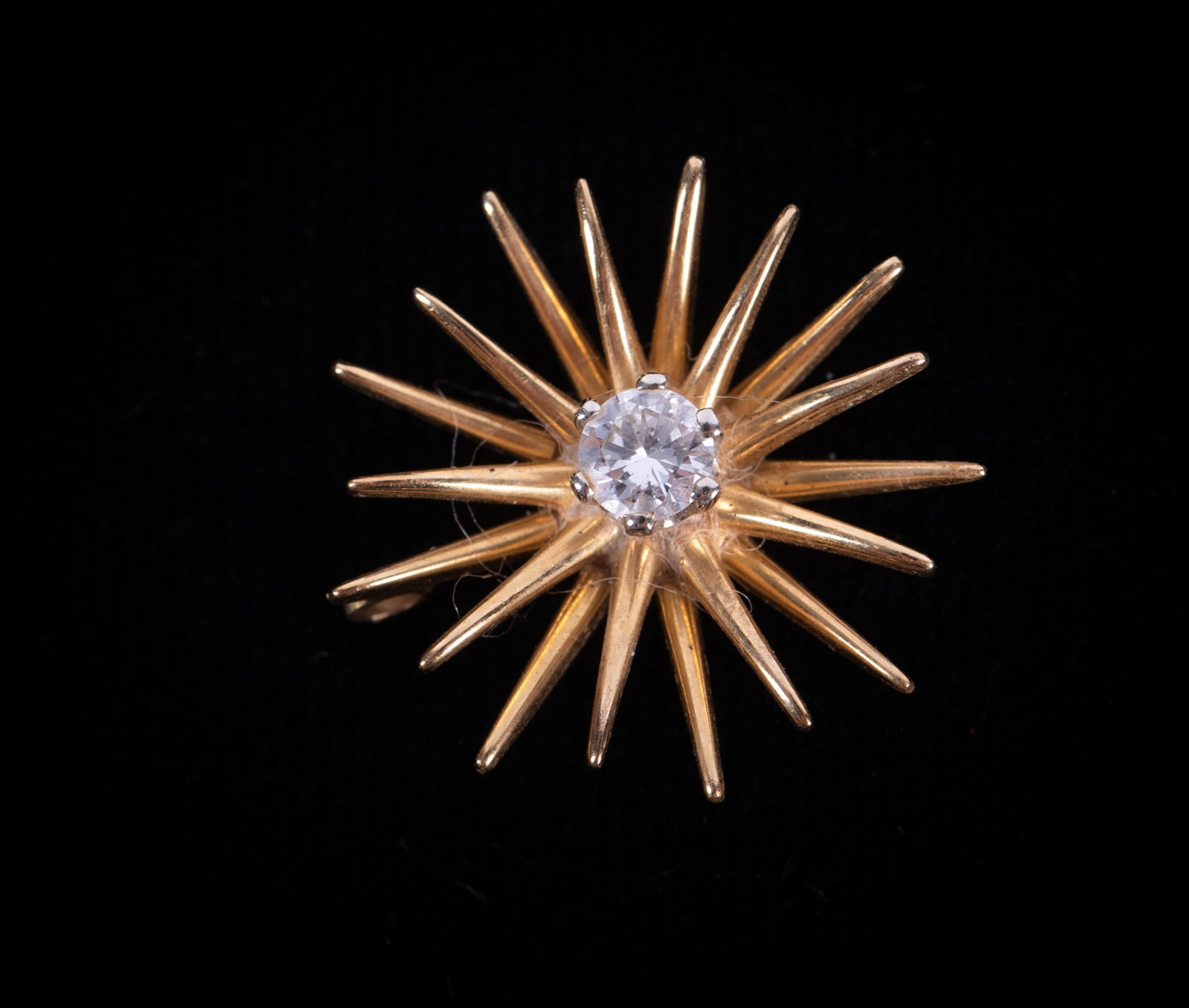 14K Yellow Gold Diamond Starburst Pendant: 14K Yellow Gold Diamond Starburst Pendant This pendant measures 14.5mm and the diamond weighs approximately .15 cts .Weight including the stone is 1.7g.