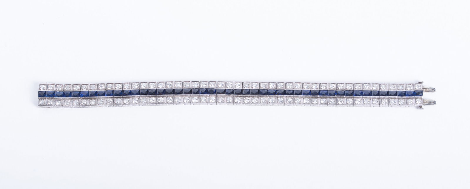 Vintage Platinum Diamond Sapphire Bracelet: Vintage Platinum Diamond Sapphire Bracelet This stunning bracelet has a continuous center row of rectangular cut blue sapphires. The outer rows have round brilliant cut diamonds set in square bezels