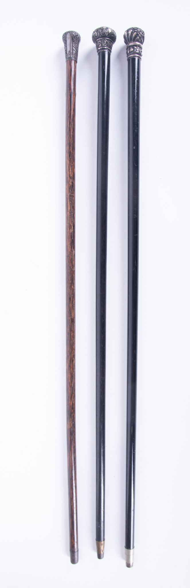 Three Antique Silver Handle Walking Canes: Three Antique Silver Handle Walking Canes The three walking sticks all having engraved and repousse silver handles, apparently unmarked. One with engraved monogram, one with owner's name P.D. Whitmore