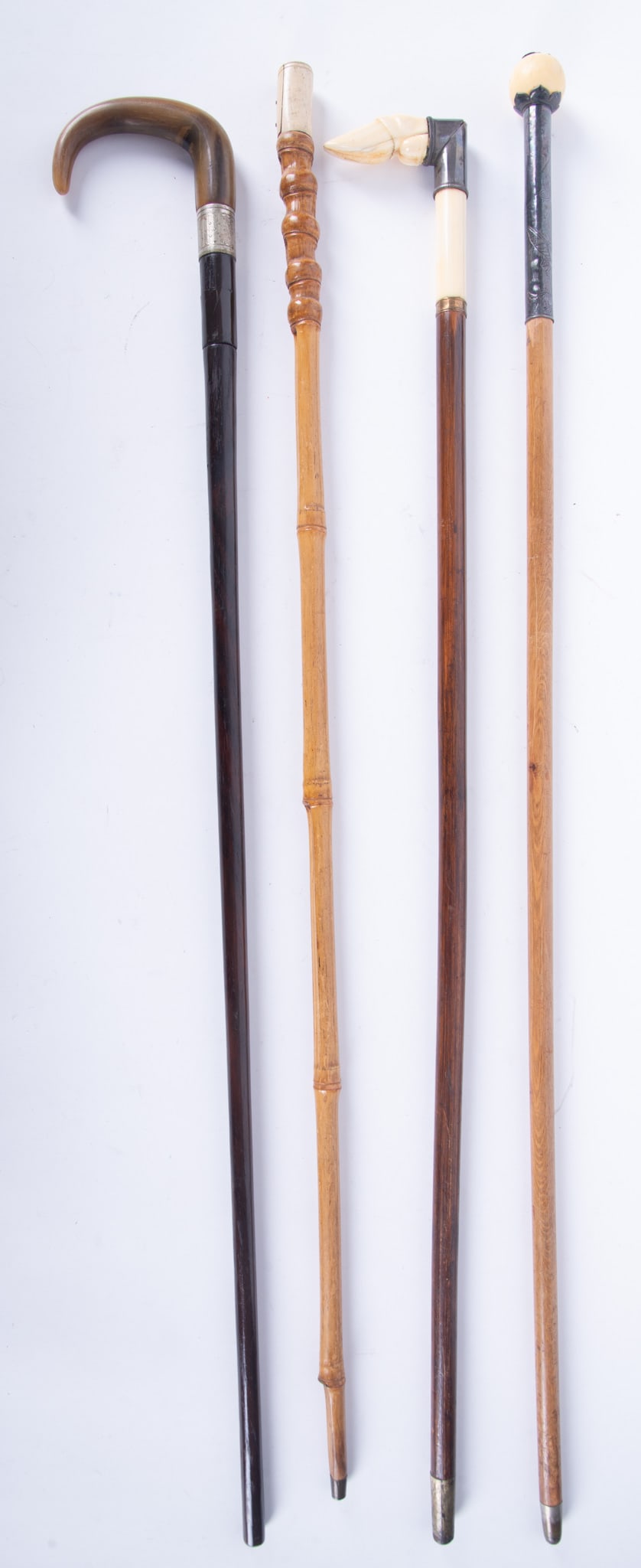 Four Horn and Carved Bone Walking Canes: Four Horn and Carved Bone Walking Canes Includes a hook-form horn handle with silver collar, a nicely carved bone handle in the shape of a hoof, a Japanese ball handle cane, and a bamboo shaft walking