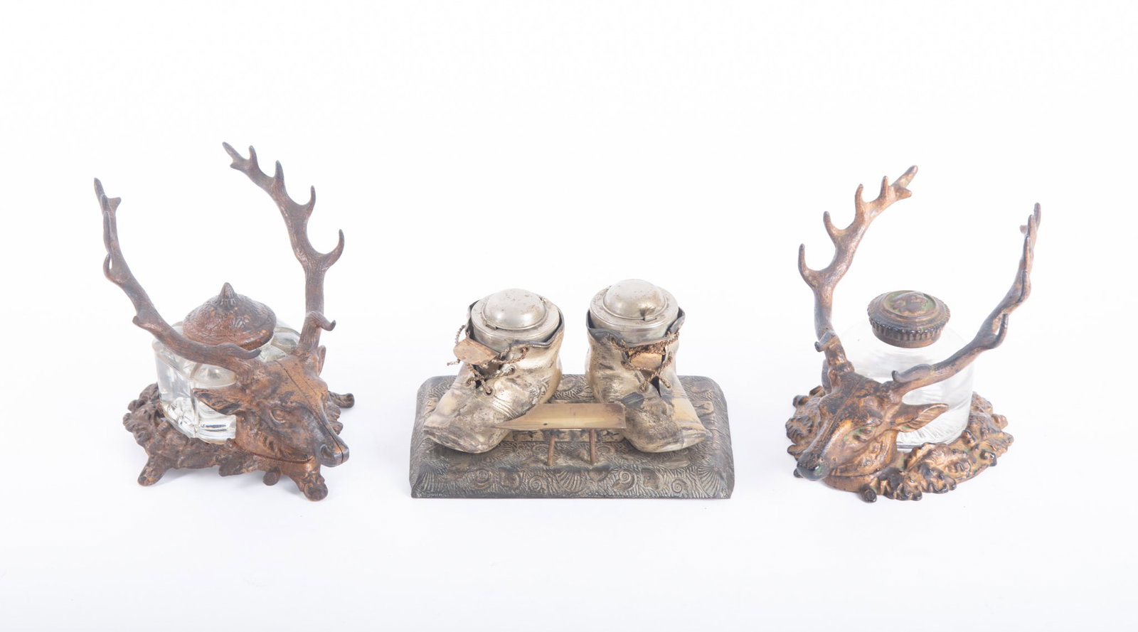 Two Antique Elk Inkwells and a Unique Baby Shoe Inkwell: Two Antique Elk Inkwells and a Unique Baby Shoe Inkwell Two "bronzed" metal Elk inkwells, the antlers creating the dip pen rack; one of the inkwells is marked Bradley and Hubbard; with an inkwell made