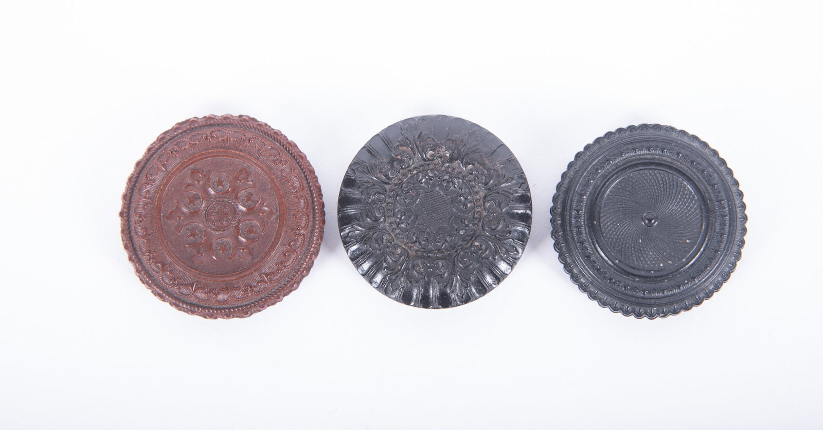 Grouping of Three Round "Oreo" Union Cases: Grouping of Three Round "Oreo" Union Cases "Geometric," sweetheart, with colorized tintype portrait of a man, 1 3/4" diameter (Krainik-733) scarce; "Scroll," sweetheart, with tintype portrait of a