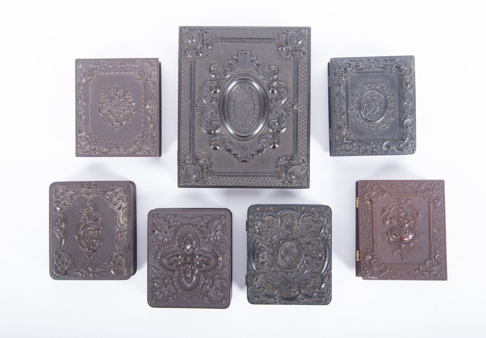 A Grouping of Quarter Plate, Ninth Plate, Union Cases: A Grouping of Quarter Plate, Ninth Plate, Union Cases "Geometric/Scroll," Littlefield, Parsons and Company, with a tinted tintype portrait of a woman (Krainik-55) scarce; "Fairy with Bird in a Rose," 