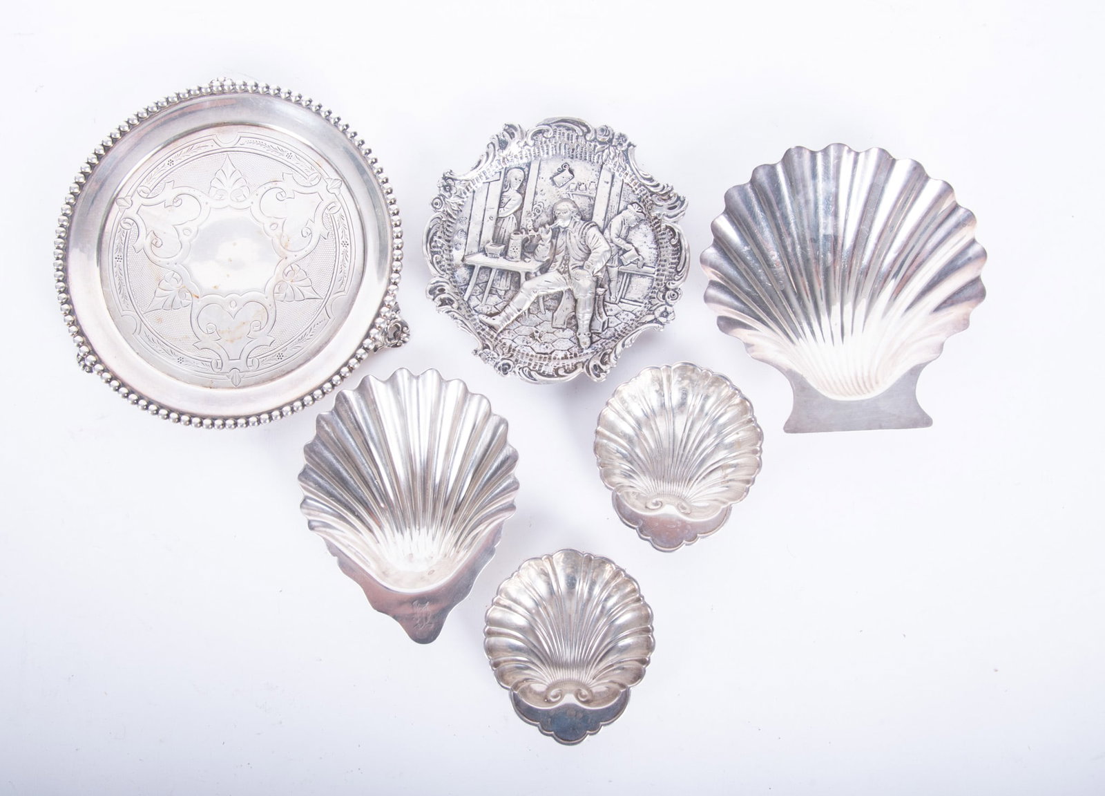 Six Sterling Silver Serving Trays Include Georg Roth and Gorham: Six Sterling Silver Serving Trays Include Georg Roth and Gorham (6) Six pieces. Georg Roth silver repousse dish featuring a man inside a tavern. Two small Gorham shell trinket dishes. Charles Rawlins 