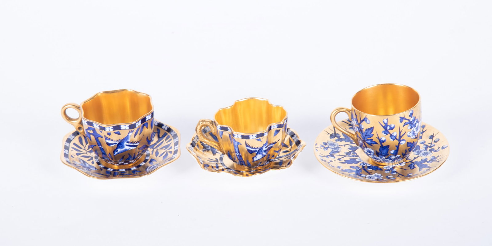 Three Fine Coalport Japonesque Demitasse Cups and Saucers: Three Fine Coalport Japonesque Demitasse Cups and Saucers England, circa 1900, 3 diminutive cups and saucers of Asian inspiration, the heavily gold gilt grounds painted with sparrows and bamboo in cob