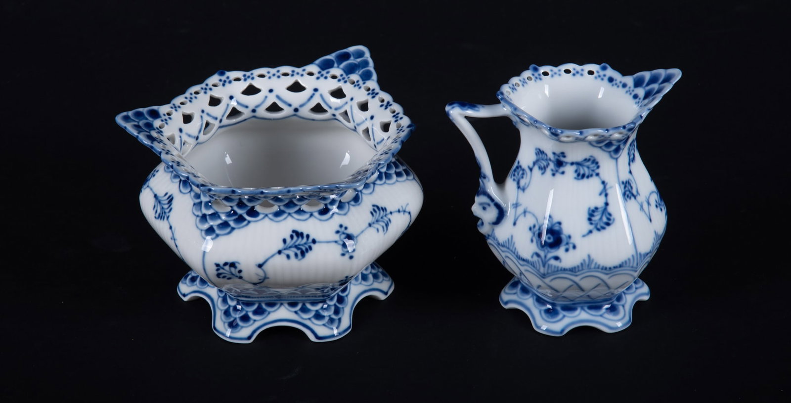 An Assembled Royal Copenhagen Blue Fluted Full Lace Creamer and Sugar: An Assembled Royal Copenhagen Blue Fluted Full Lace Creamer and Sugar Denmark, an open sugar bowl and cream pitcher in Royal Copenhagen's full lace pattern, featuring delicate blue botanical floral de