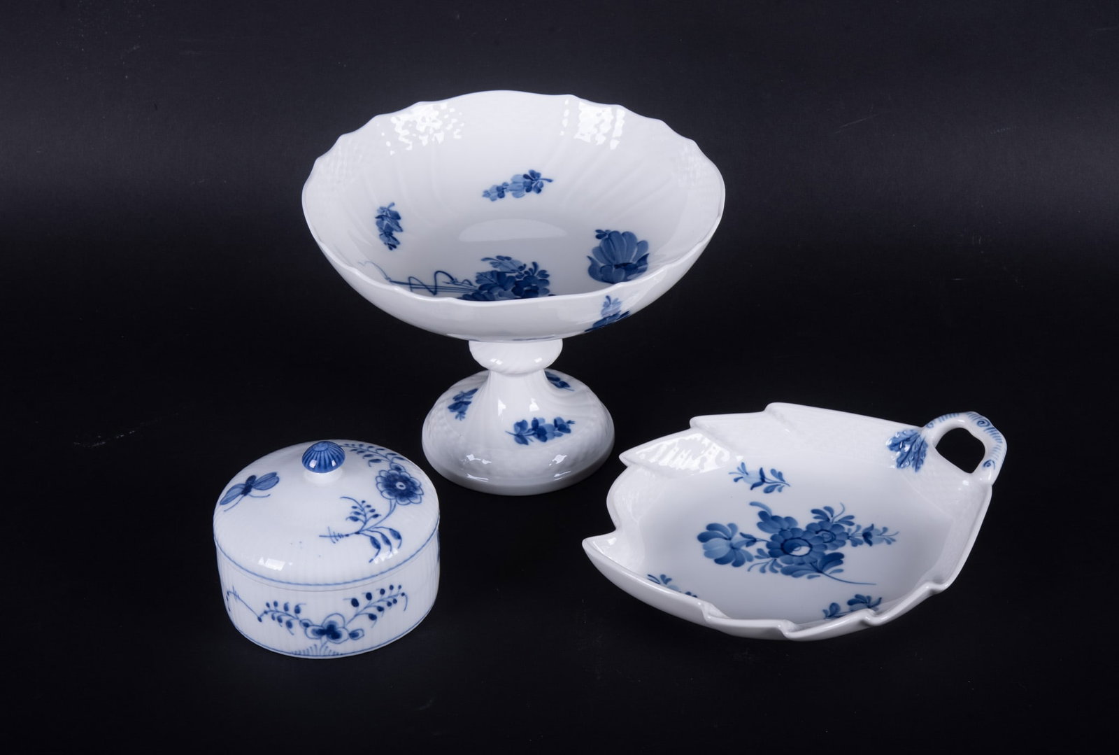Three Royal Copenhagen Blue Flowers Pattern Porcelains: Three Royal Copenhagen Blue Flowers Pattern Porcelains Denmark, the group includes a circa 1975 Blue Flowers compote, a circa 1980 Blue Flowers leaf shaped dish, and a Blue Flowers round covered box.
