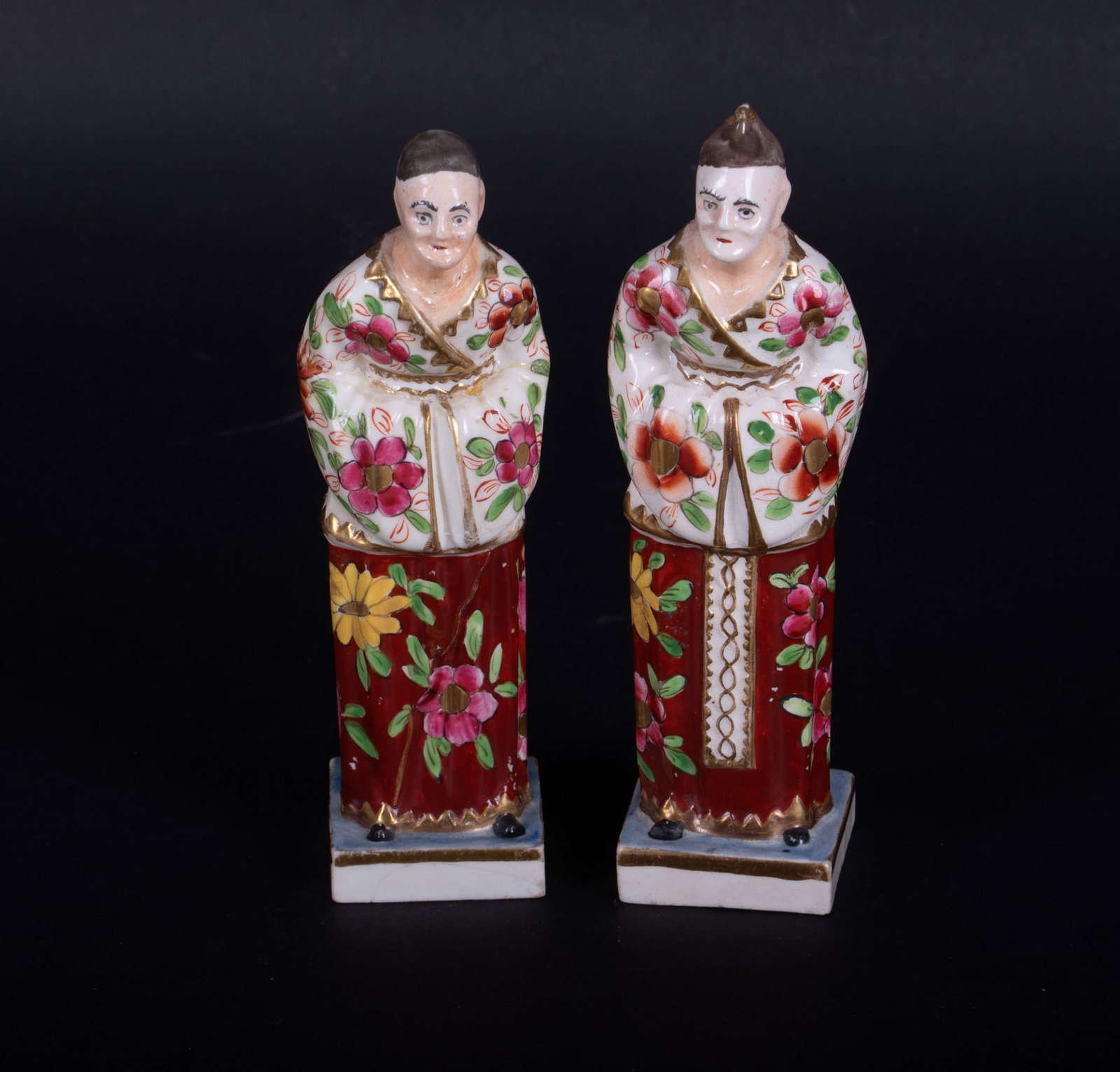 A Rare Pair of Early English Porcelain Chinoiserie Court Figures: A Rare Pair of Early English Porcelain Chinoiserie Court Figures Likely 18th century, in the manner of Derby, a pair of painted porcelain figures in long Asian inspired floral robes, both perched on