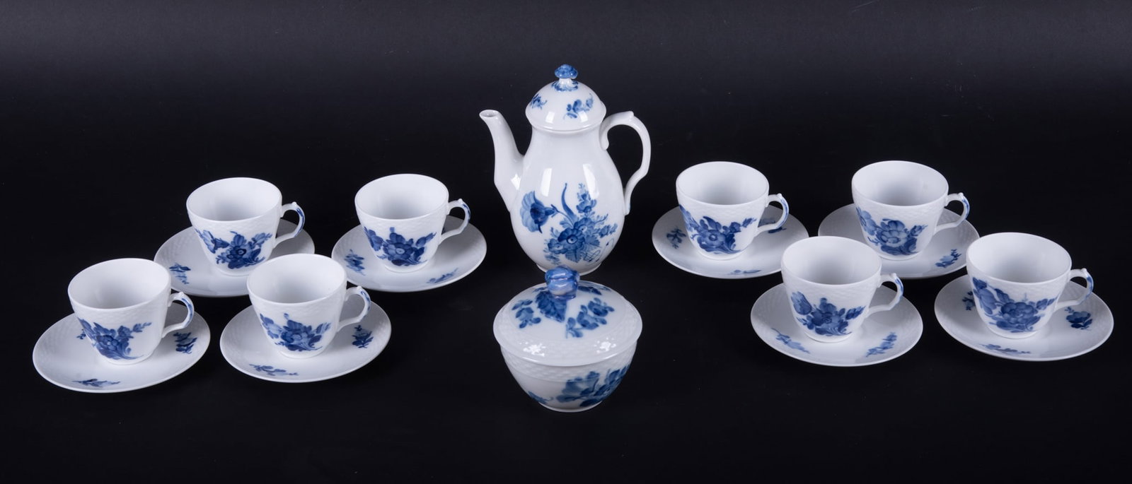 An Assembled Royal Copenhagen Blue Flowers Tea Set: An Assembled Royal Copenhagen Blue Flowers Tea Set Denmark, all in Royal Copenhagen's blue flower pattern, the lot consists of 8 cups and saucers, a covered sugar bowl and a diminutive teapot. Saucer: