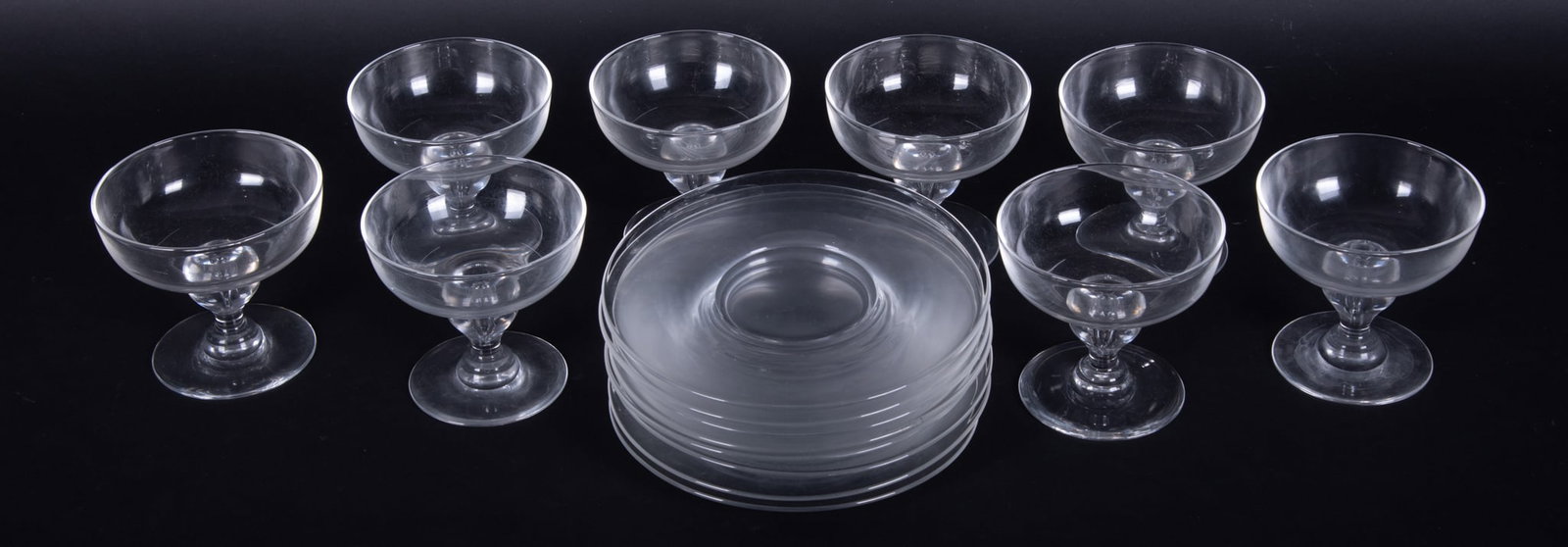 A Set of Eight Steuben "Teardrop" Champagnes, or Sherbets with Underplates: A Set of Eight Steuben "Teardrop" Champagnes, or Sherbets with Underplates Teardrop to stem, each marked Steuben. Height: 4 inches; Diameter of coupes: 4 inches; Diameter of plates: 7 inches