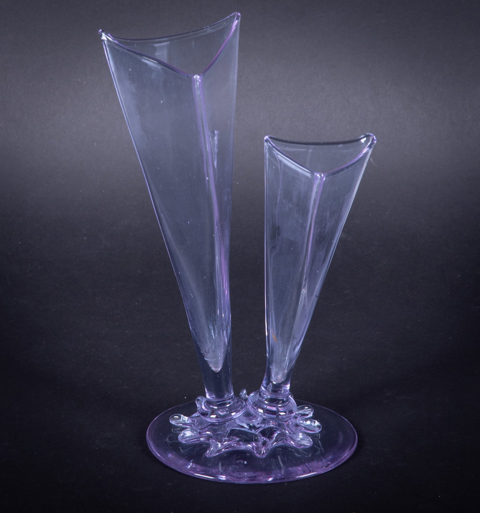 A Steuben Art Deco Two-Prong Amethyst Glass Vase: A Steuben Art Deco Two-Prong Amethyst Glass Vase Bearing Steuben acid-etch mark to base, a 2-pronged 3-corner vase in a light amethyst color. 9 3/4 inches tall