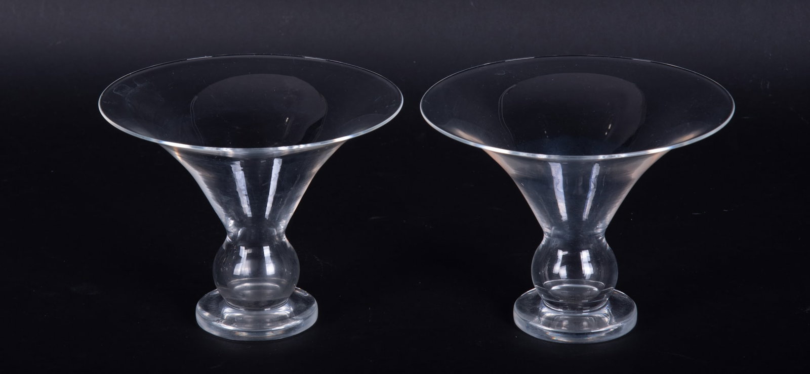 A Pair of Steuben Flared Glass Vases: A Pair of Steuben Flared Glass Vases Two clear glass open form vases with ball knops on round feet, each with etched signatures. Height: 4 5/8 inches; Diameter: 6 1/4 inches