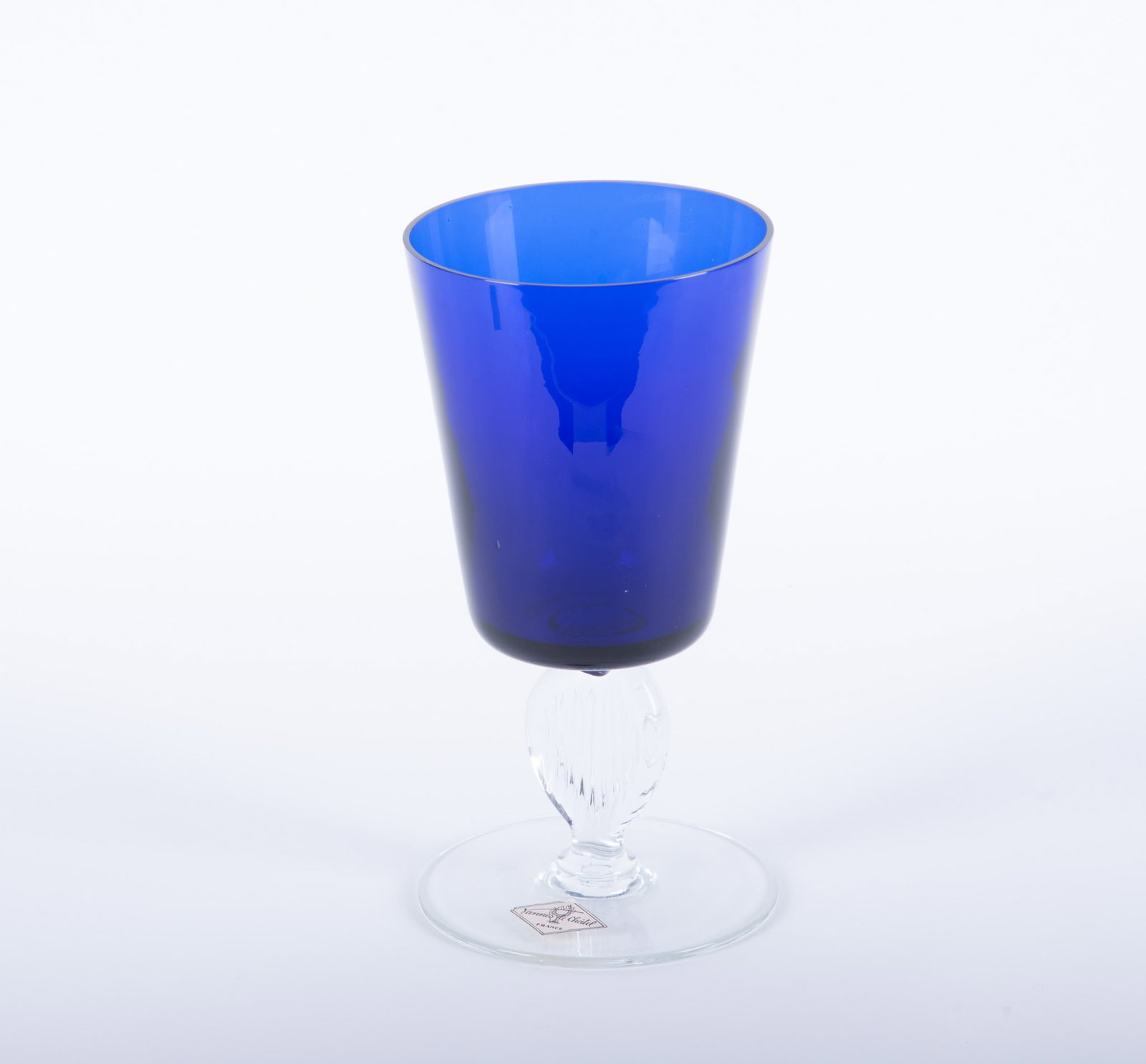 A Large Hand-Blown Vannes le Chatel Cobalt and Clear Crystal Vase: A Large Hand-Blown Vannes le Chatel Cobalt and Clear Crystal Vase France, 20th century, a conical form cobalt vase rising on a oval and impressed decorated stem. 5 1/2 x 10 5/8 inches