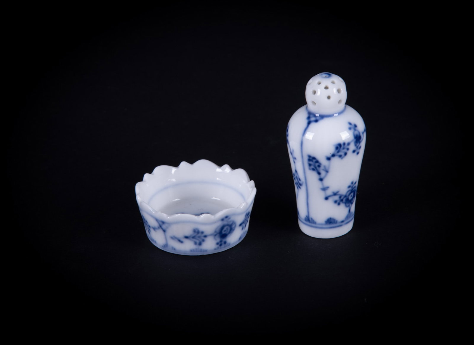 A Rarely Found Pair of Royal Copenhagen Blue Fluted Individual Salt and Pepper Shakers: Denmark, a diminutive pair of open salt with accompanying pepper shaker. Royal Copenhagen, late 20th century. Pepper: 2 1/2 inches tall