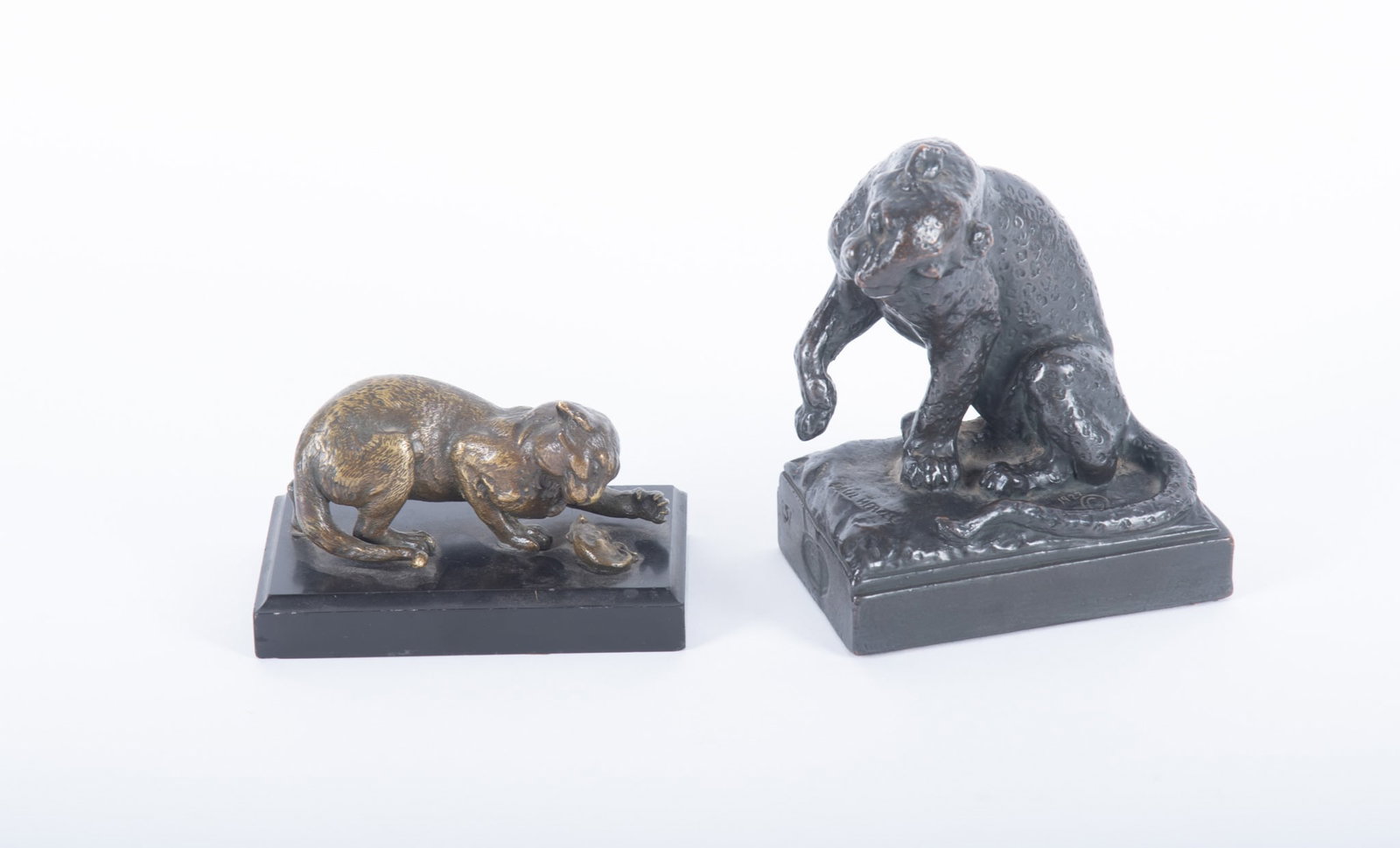 A Bronze Figure Group of a Cat and Rodent, paired with a Paul Herzel Bookend: A Bronze Figure Group of a Cat and Rodent, paired with a Paul Herzel Bookend An interesting bronze figure group of a crouched cat perched over a dead rodent, on a black marble plinth (apparently