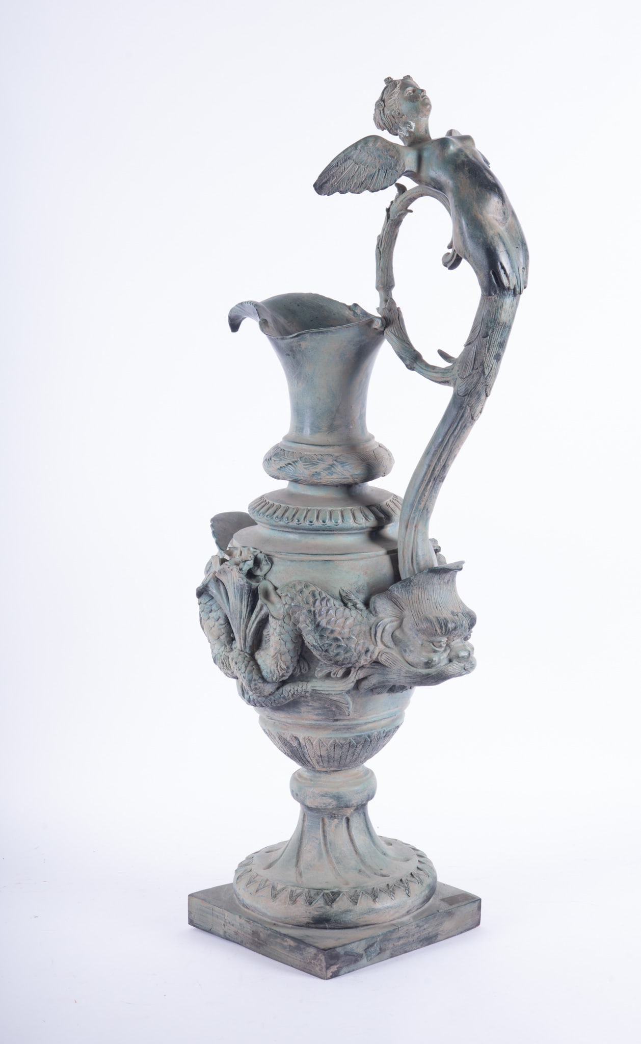 Large Continental Style Verdigris Bronze Ewer: Large Continental Style Verdigris Bronze Ewer This large ewer features a winged maiden as the handle with Regency Dolphin figures around the body. Rests on a square base 9 x 9 inches. 36 x 17 x 12