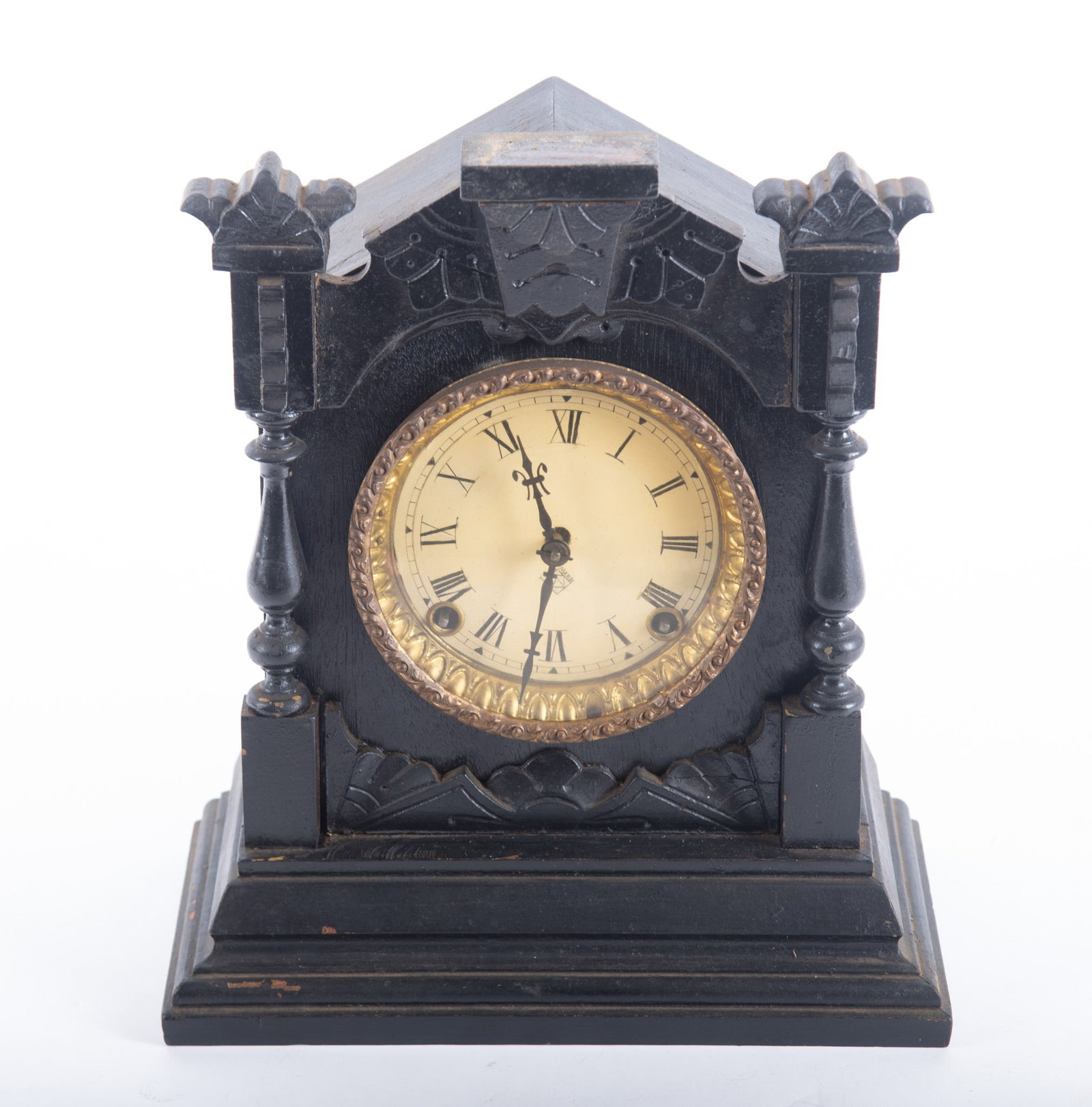 Antique Ebonized Shelf Clock: Antique Ebonized Shelf Clock With all around Gothic Revival decoration with a glass having gilt metal highlights door opening to show a circular dial with Roman Numeral chapter ring centering full vas