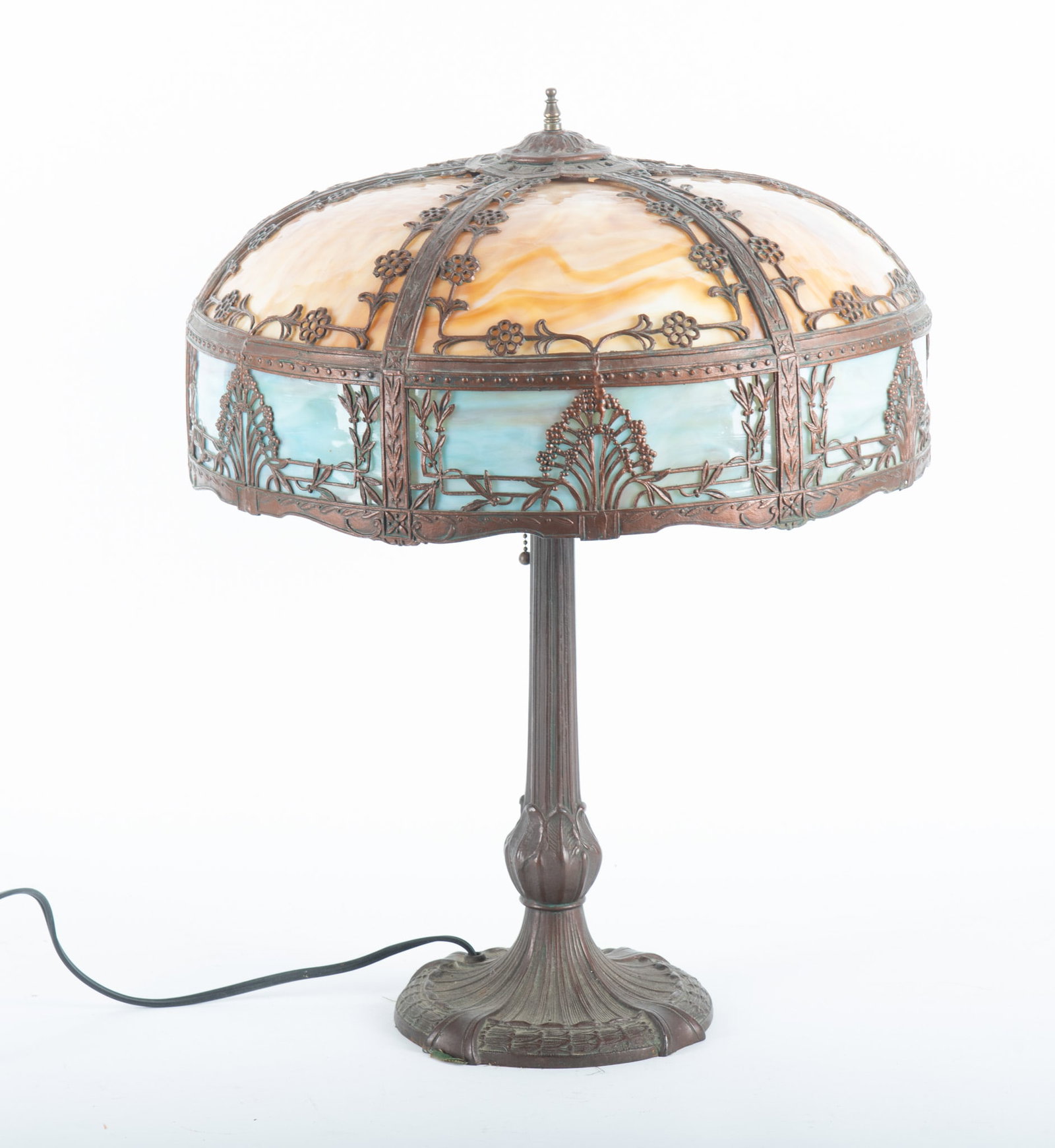 Antique Art Nouveau Style 12 Panel Slag Glass Lamp: Antique Art Nouveau Style 12 Panel Slag Glass Lamp 12 slag glass panels with 6 in an amber tone and 6 in a blue tone surrounded by a foliate design. The base has leaf form designs. Unmarked. Base meas