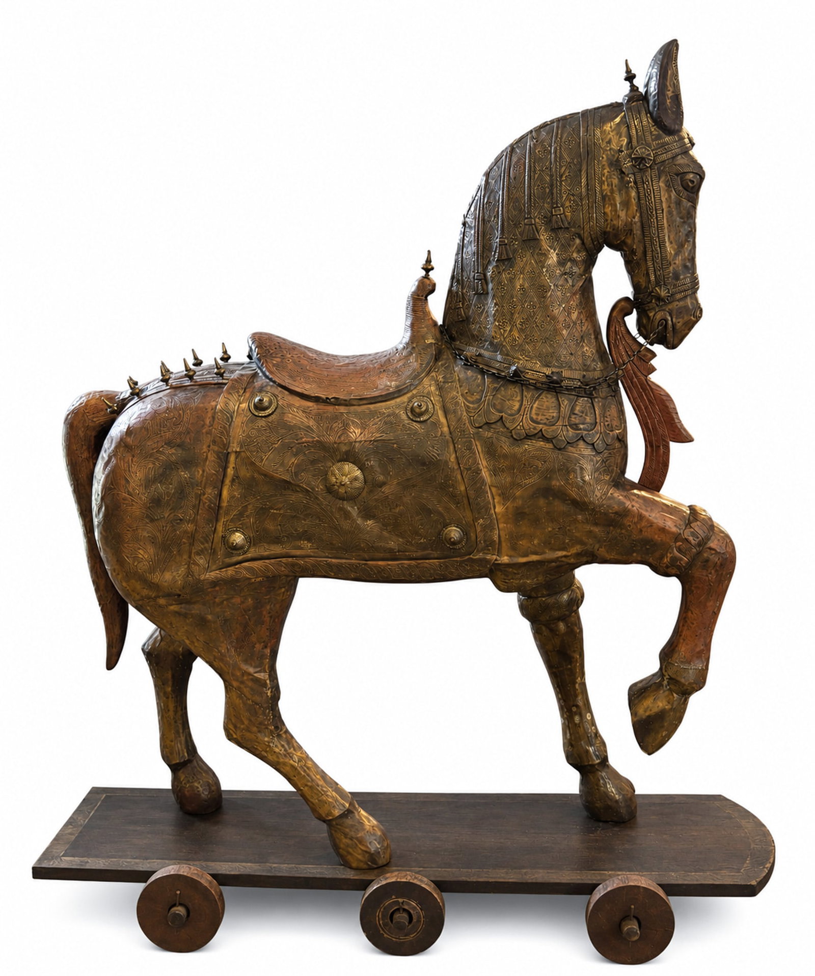 Life-Size Figure Of A Horse, Indian (20th Century): Life-Size Figure Of A Horse, Indian (20th Century) Carved wooden figure overlaid in punched tin mounted on a wooden platform with six wheels. 70 1/2 x 18" inches. Horse without base: 74.5" height