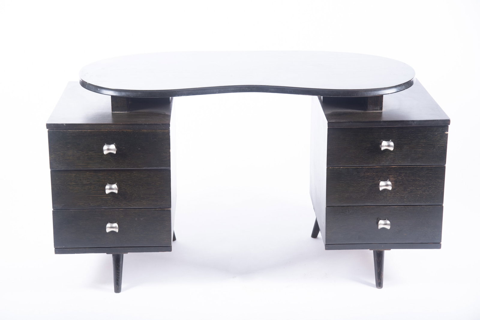 Mid-Century Modern Desk in the Manner of Gilbert Rhode: Mid-Century Modern Desk in the Manner of Gilbert Rhode Kneehole form, with ebonized, kidney shaped surface over the two tower supports with three drawers each 29 1/2 x 53 1/2 x 23 inches