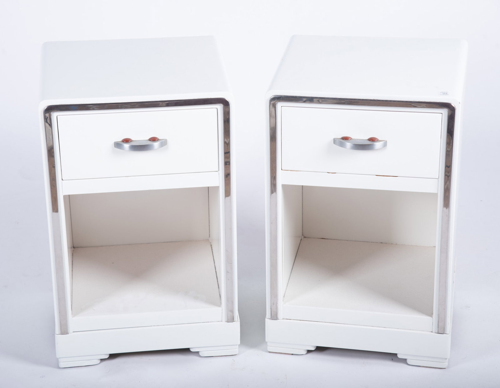 Norman Bel Geddes, American (1893-1958): Norman Bel Geddes, American (1893-1958) A Pair of Art Deco white metal nightstands for Simmons Manufacturing 23 1/4 x 15 x 14 inches