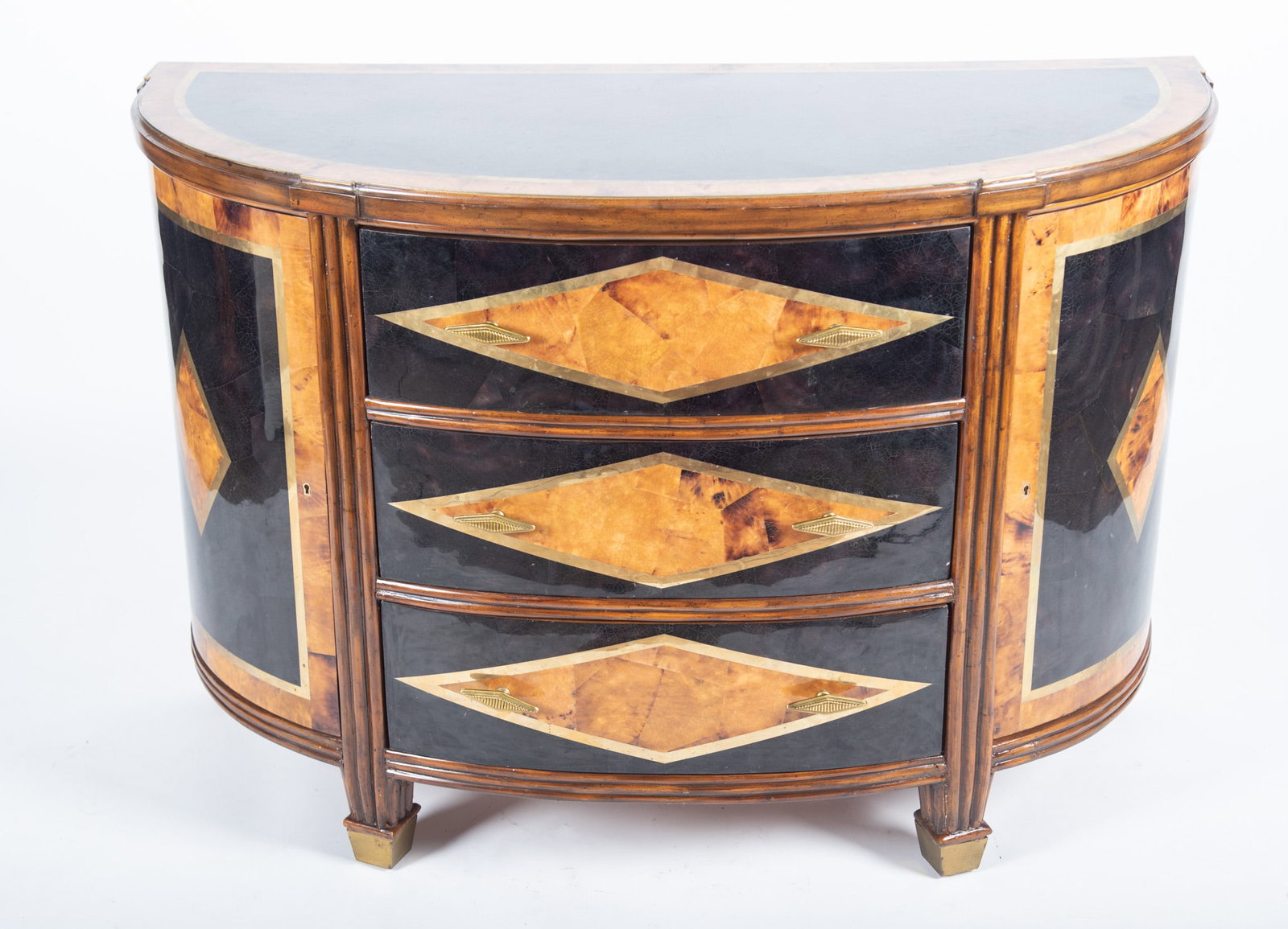 Maitland Smith Three Drawer Cabinet: Maitland Smith Three Drawer Cabinet Three drawers each with geometric burl paneling with brass inlay centering a pair of matching cupboard doors ending on tapering reeded legs. 33 x 48 x 21 inches