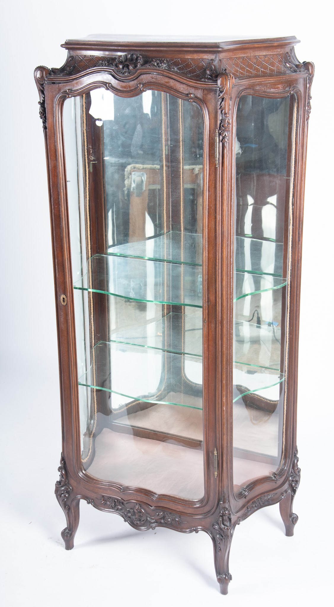 Louis XV Style Vitrine Cabinet: Louis XV Style Vitrine Cabinet Late nineteenth century with serpentine glass sides and front with mirrored back and all over floral carving all above a shaped apron and cabriole legs. 59 1/2 x 15 1/2 