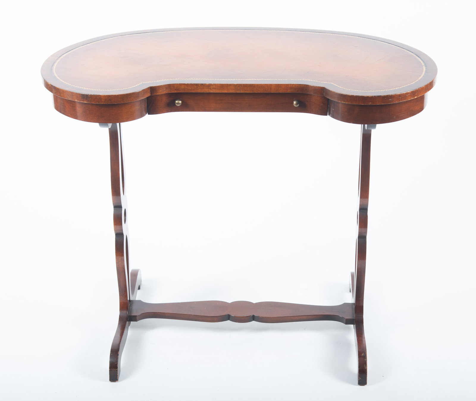 Semi Antique Mahogany Kidney Form Ladies Writing Desk: Semi Antique Mahogany Kidney Form Ladies Writing Desk The shaped leather and embossed top above a single frieze drawer supported on shaped and pierced twin supports and stretcher. 28 x 36 x 20 inches