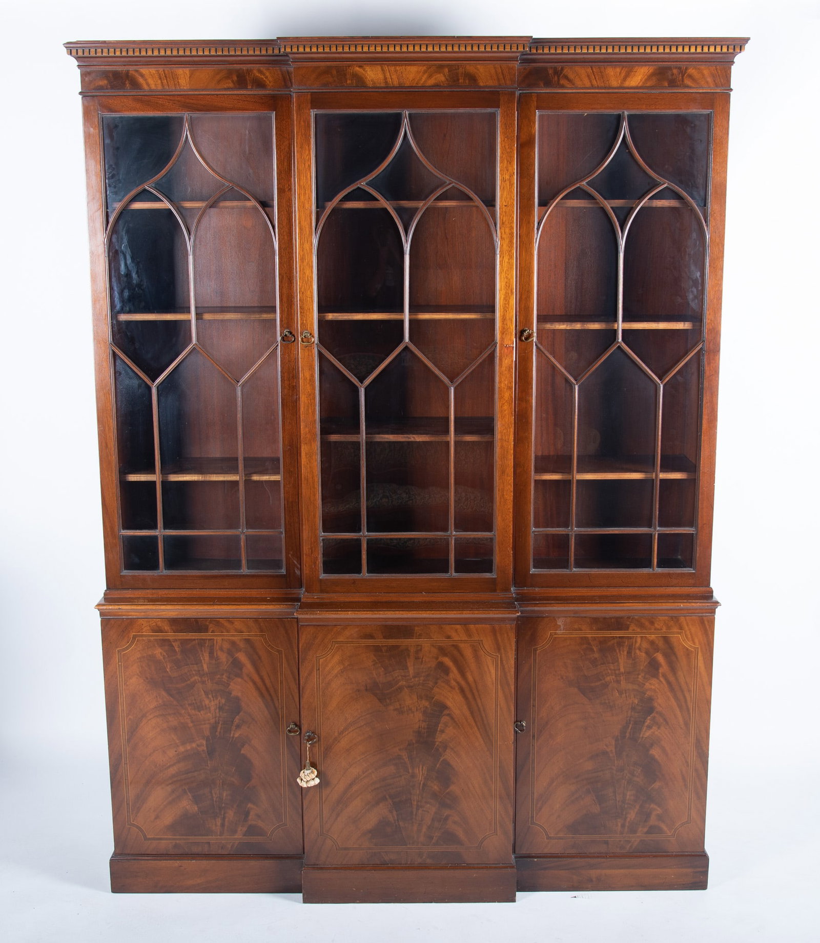Georgian design two-member breakfront china cabinet: Georgian design two-member breakfront china cabinet Dentil molding above four glass doors and four cupboard doors. length: 60'' height: 80'' depth: 13''