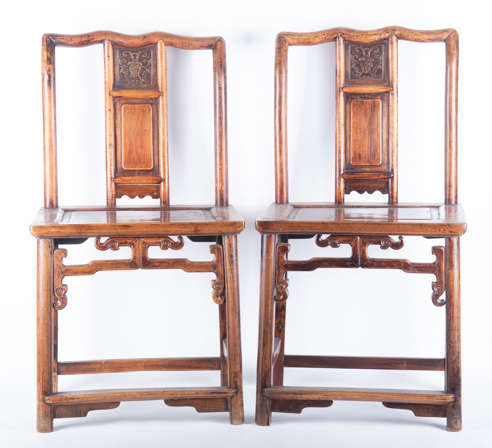 Pair Of Asian Design Side Chairs: Pair Of Asian Design Side Chairs Serpentine head rail above a shaped back rest with raised Chinese decoration all above a recessed paneled seat, pierced apron and straight legs. 37 x 20 x 15 inches ea