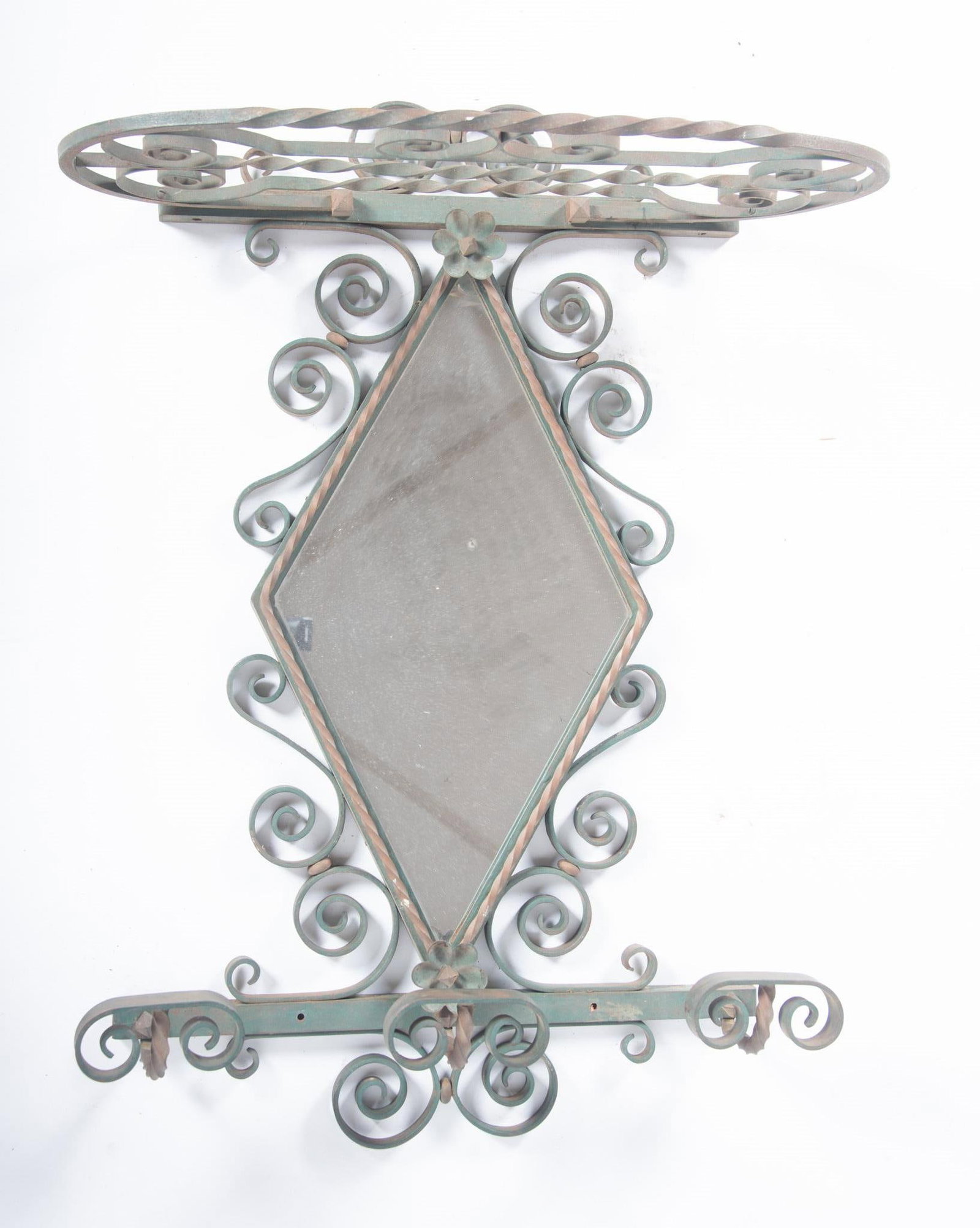 Art Deco Wrought Iron Wall Mirror in the Style of Oscar Bach: Art Deco Wrought Iron Wall Mirror in the Style of Oscar Bach Diamond form mirror centers the scroll decorated framing with three (3) hat hooks high and an open ledge below. 33 x 24 x 12 1/2 inches