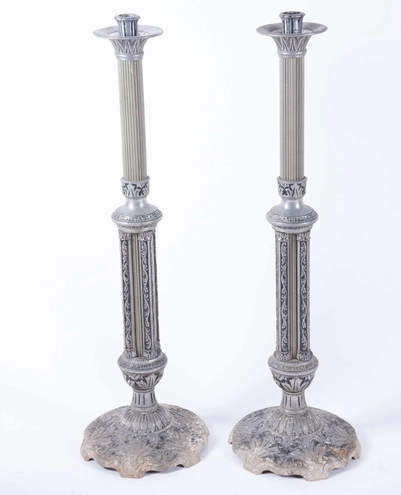 Pair of Antique Aluminum Carved Regency Pedestal Candle Bases: Pair of Antique Aluminum Carved Regency Pedestal Candle Bases Floor standing fluted columns with Regency inspired details and a distressed grey finish, with intricate carvings on the base and capitol 