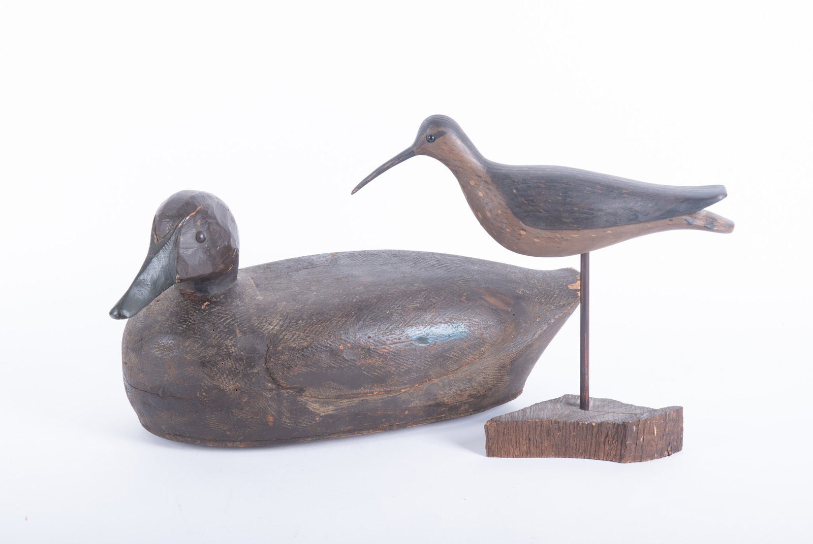 Decoy, Black Duck, Long Point, Ontario; together with Shore Bird by W.E.K: Decoy, Black Duck, Long Point, Ontario; together with Shore Bird by W.E.K Carved and polychrome decorated Black Duck measures 18 x 9 x 7 inches; together with a carved wood shorebird monogrammed