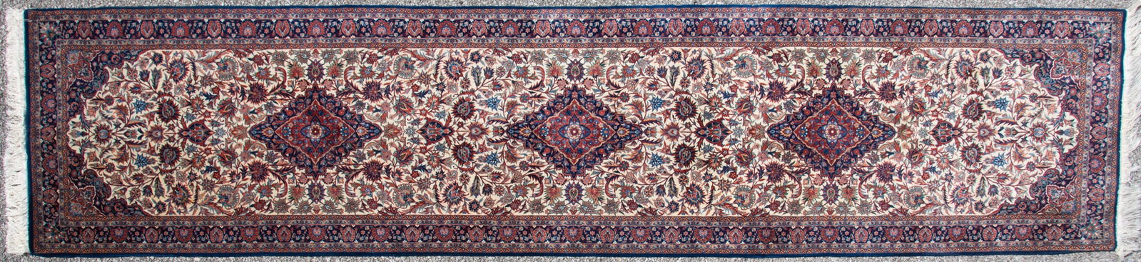 Handwoven Persian Kashan Runner: Handwoven Persian Kashan Runner The leaf, floral and garland field with three diamond form medallions on an ivory background with dark foliate spandrels amid a matching primary border. 2' 9" x 11' 8"