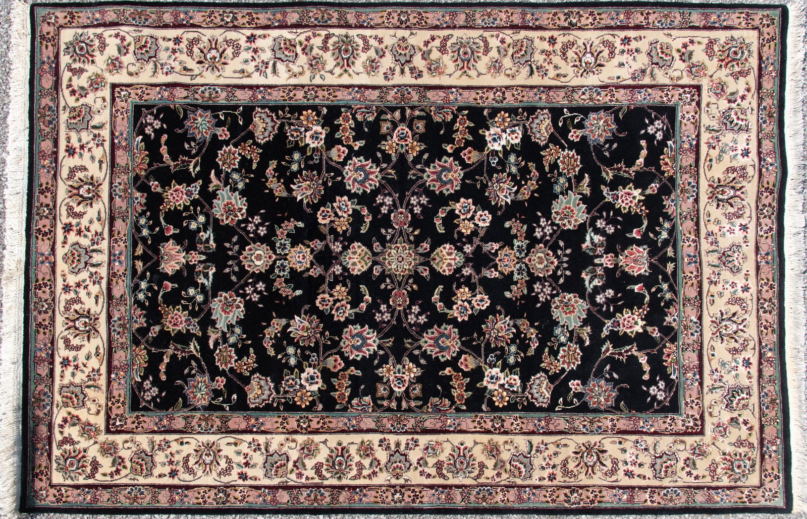 Handwoven Persian Area Rug: Handwoven Persian Area Rug The dark field having a continuous floral and vine pattern with inlaid silk throughout and a ivory primary border and guard borders. 4' 2" x 5' 11"