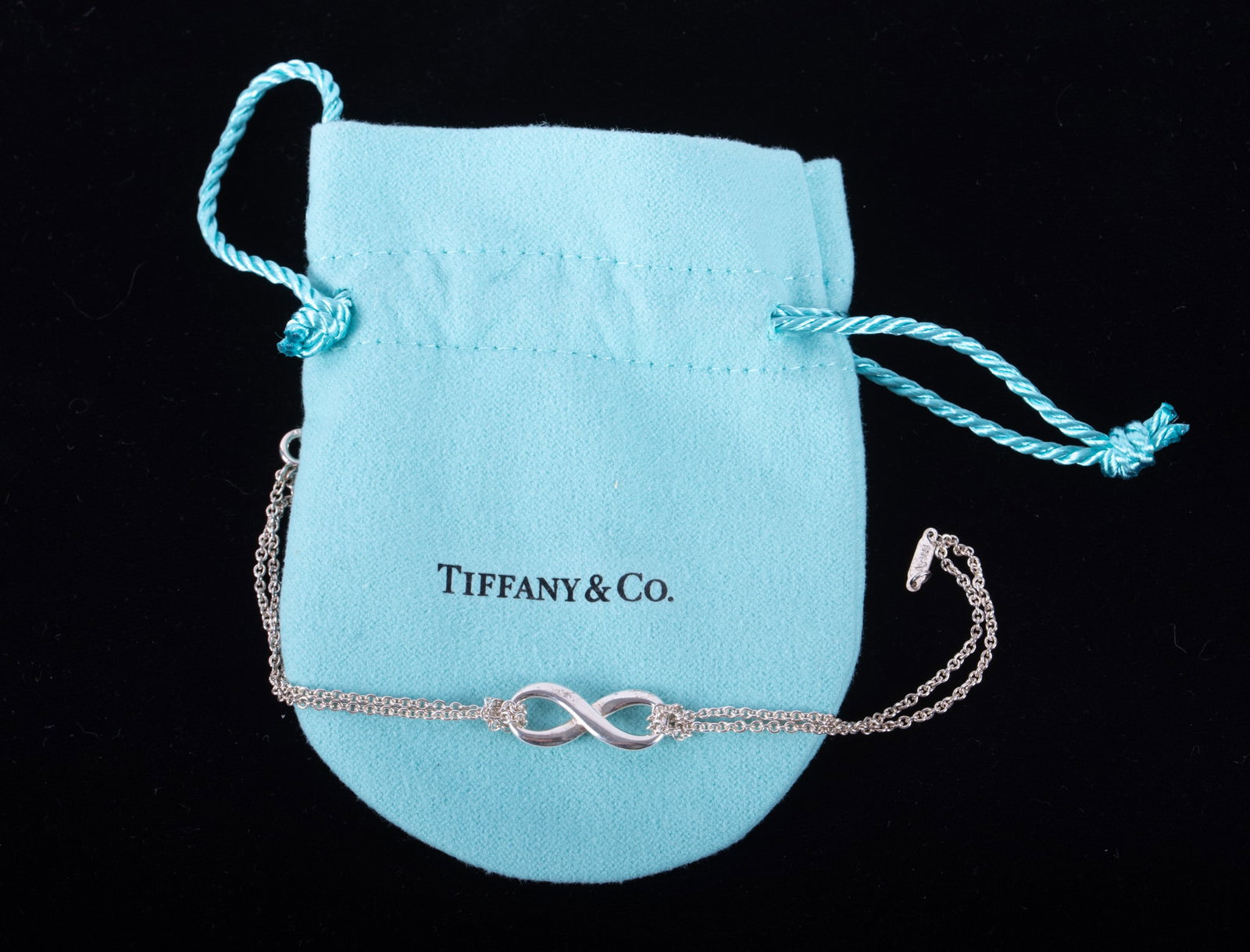 Tiffany & Co Infinity Bracelet in Sterling Silver: Tiffany & Co Infinity Bracelet in Sterling Silver The bracelet measures 6 1/2 inches long and weighs 3.2g.